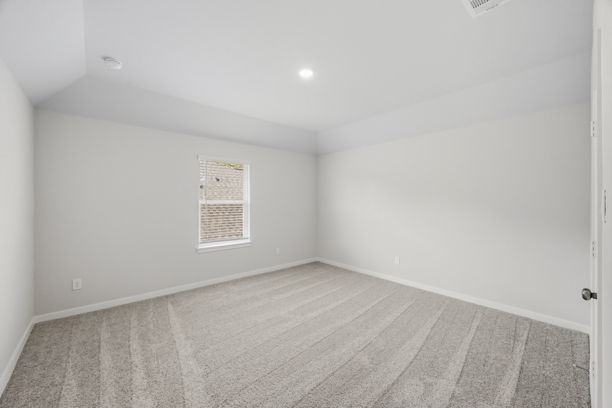 A room with a tile floor and a door.