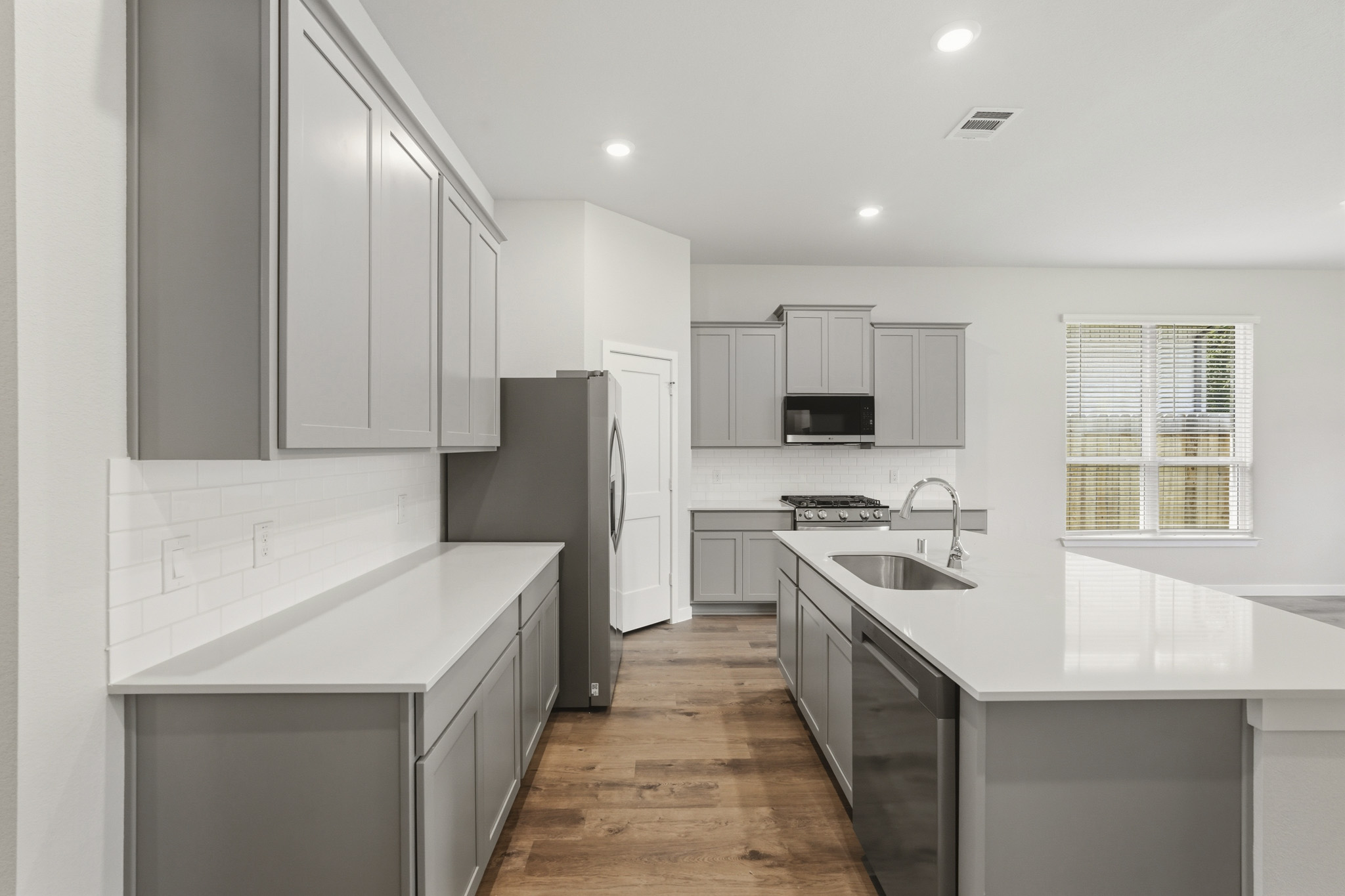 A kitchen with white cabinets.