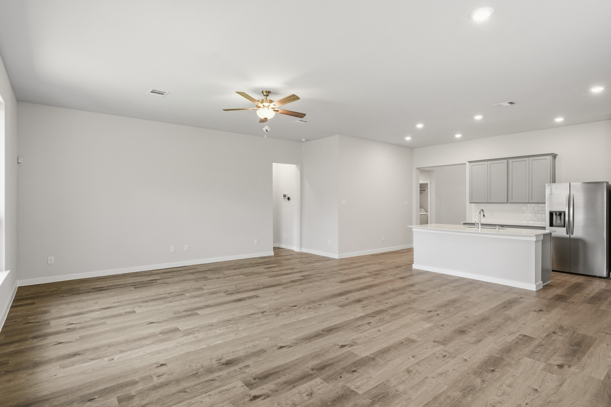 A kitchen with a wood floor.