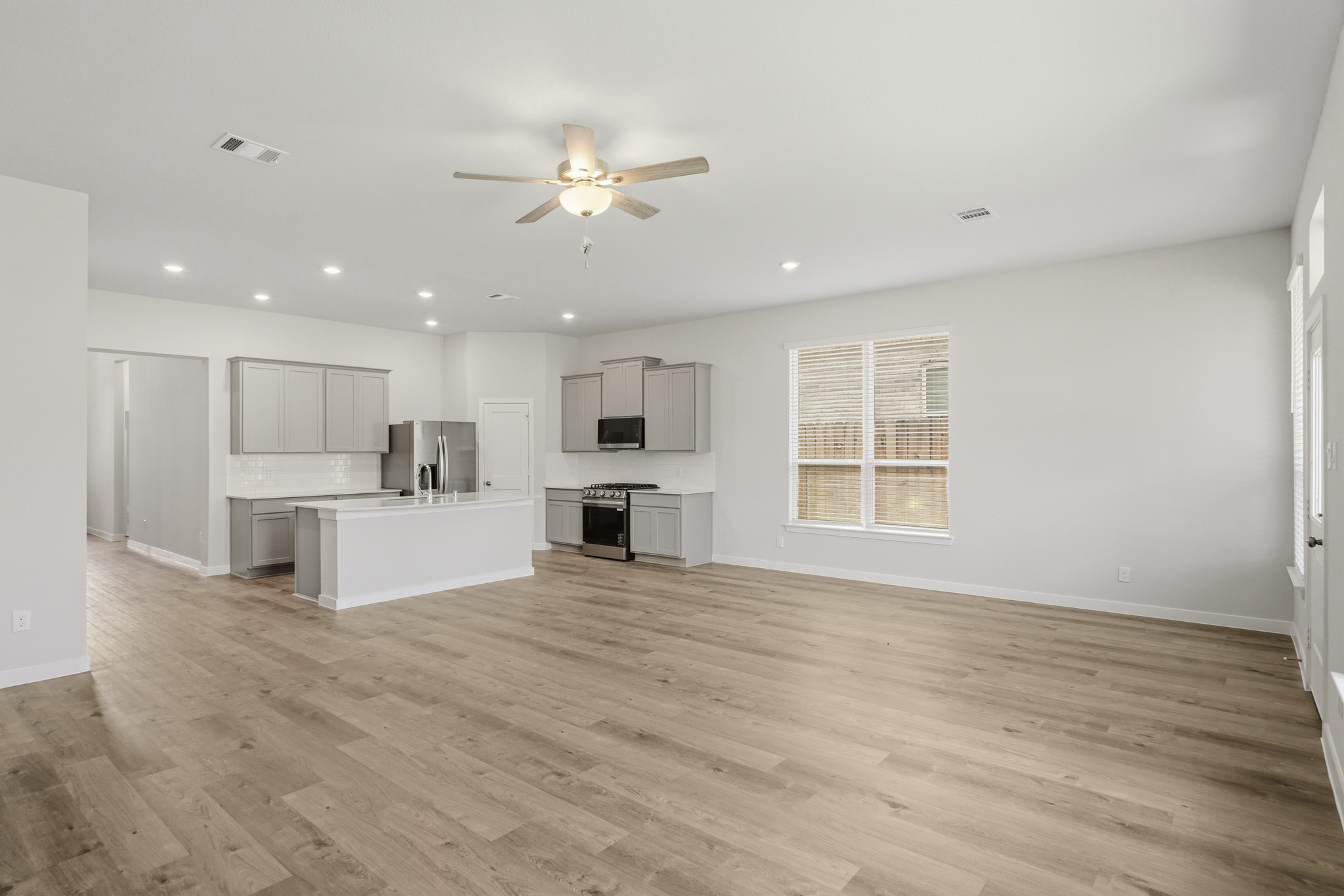 A large kitchen with a wood floor.