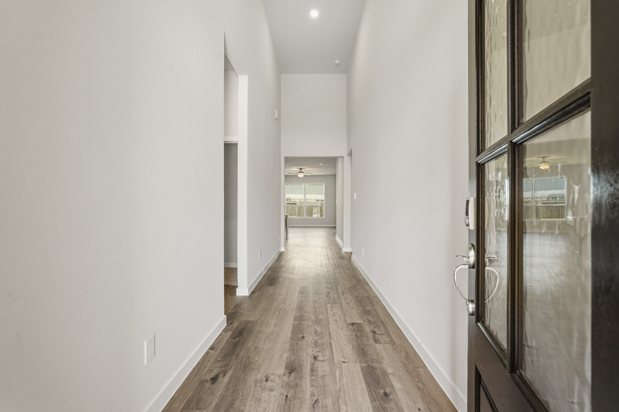 A hallway with glass doors.