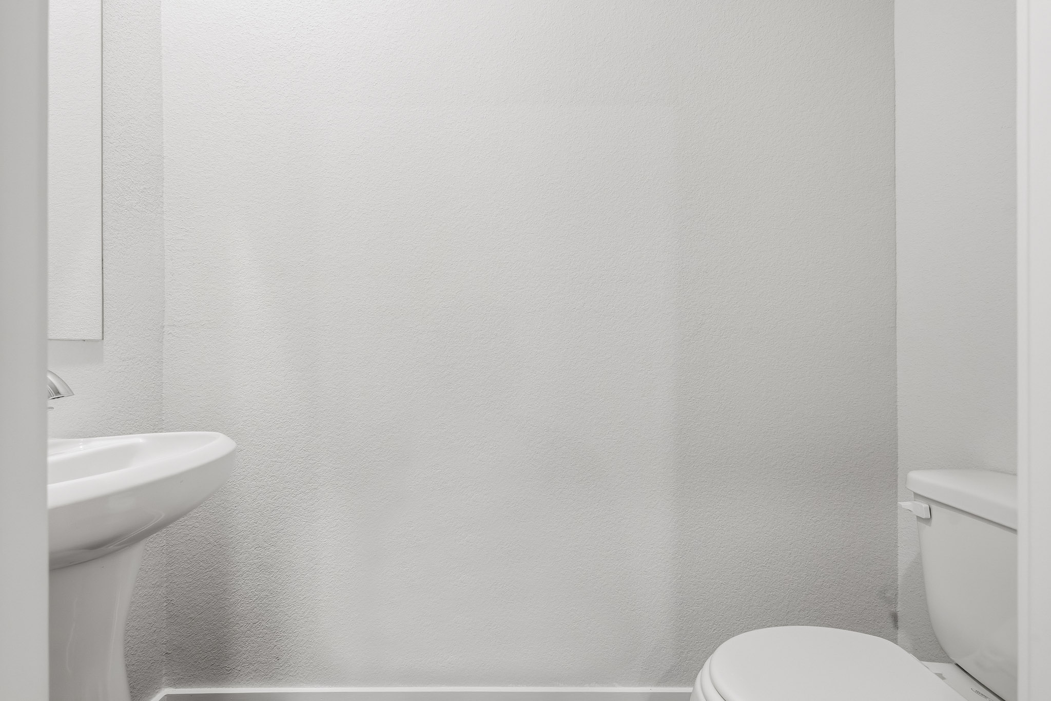 A bathroom with a toilet and sink.