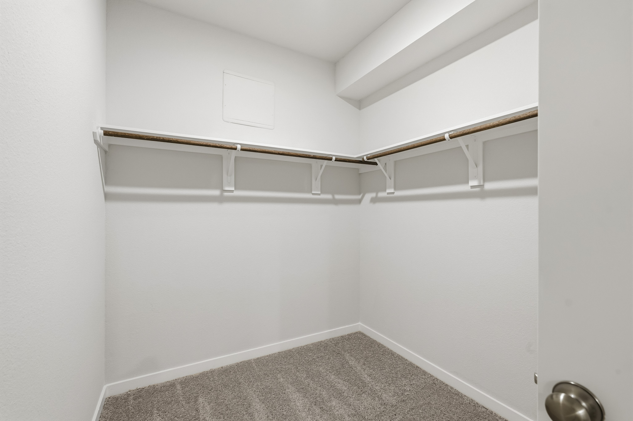 A white room with a metal bar.