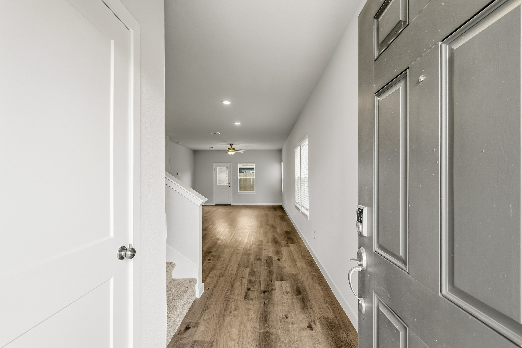 A hallway with white doors.