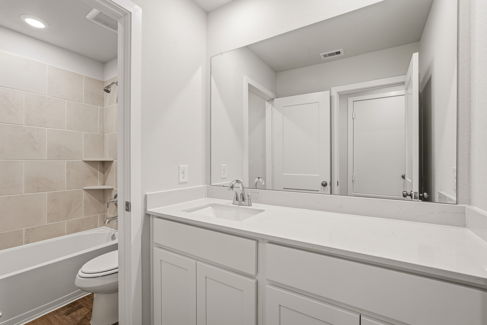 A bathroom with a tub sink and toilet.