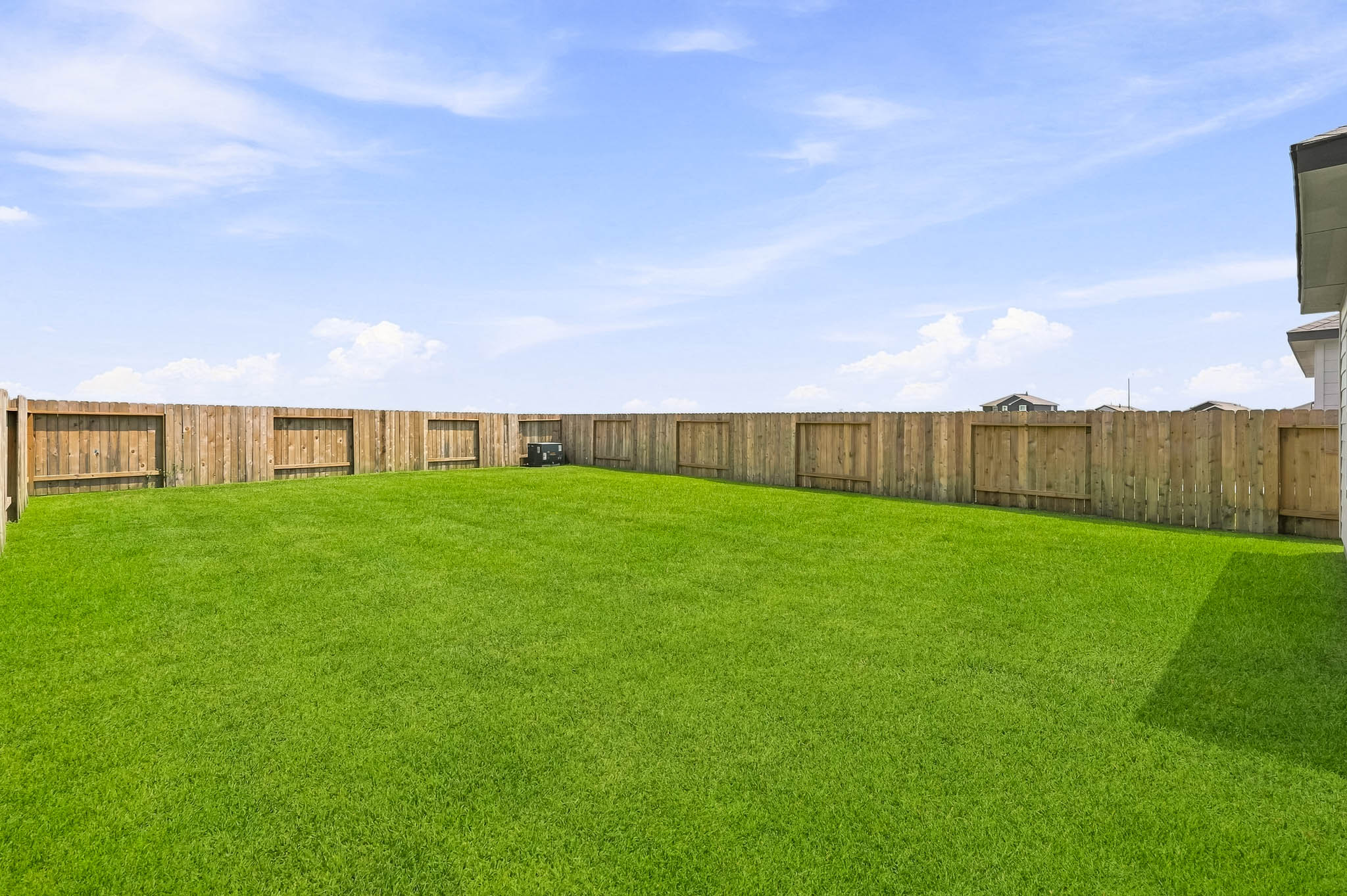 A fenced in grass field.