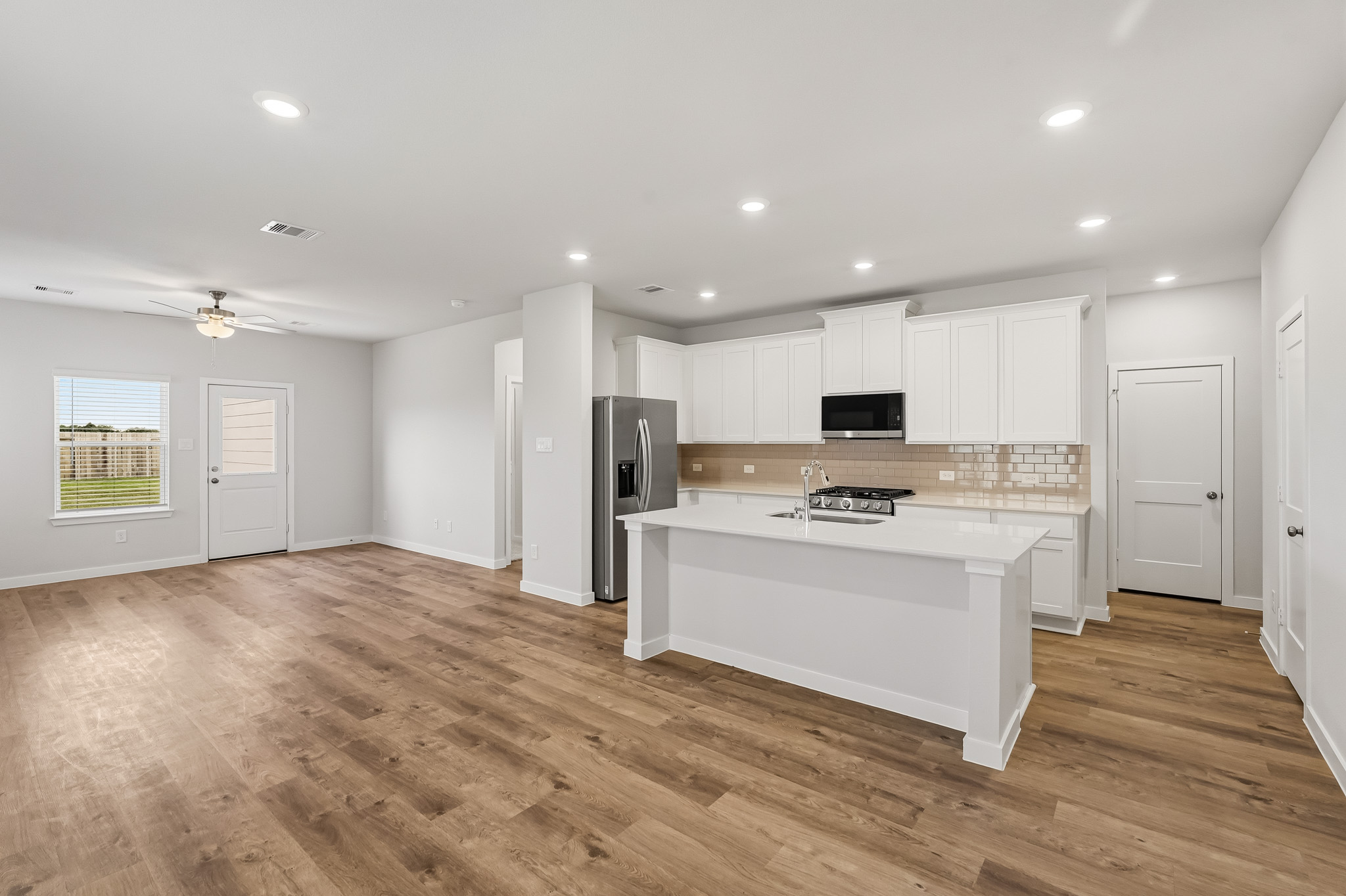 A kitchen with white cabinets.