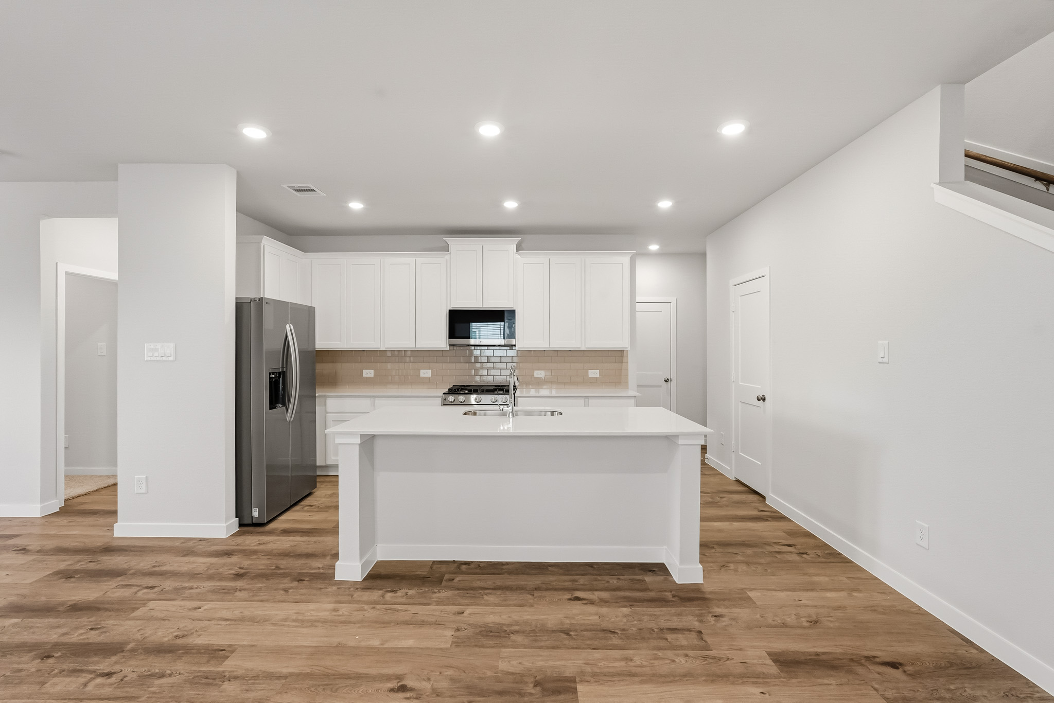 A kitchen with white cabinets.