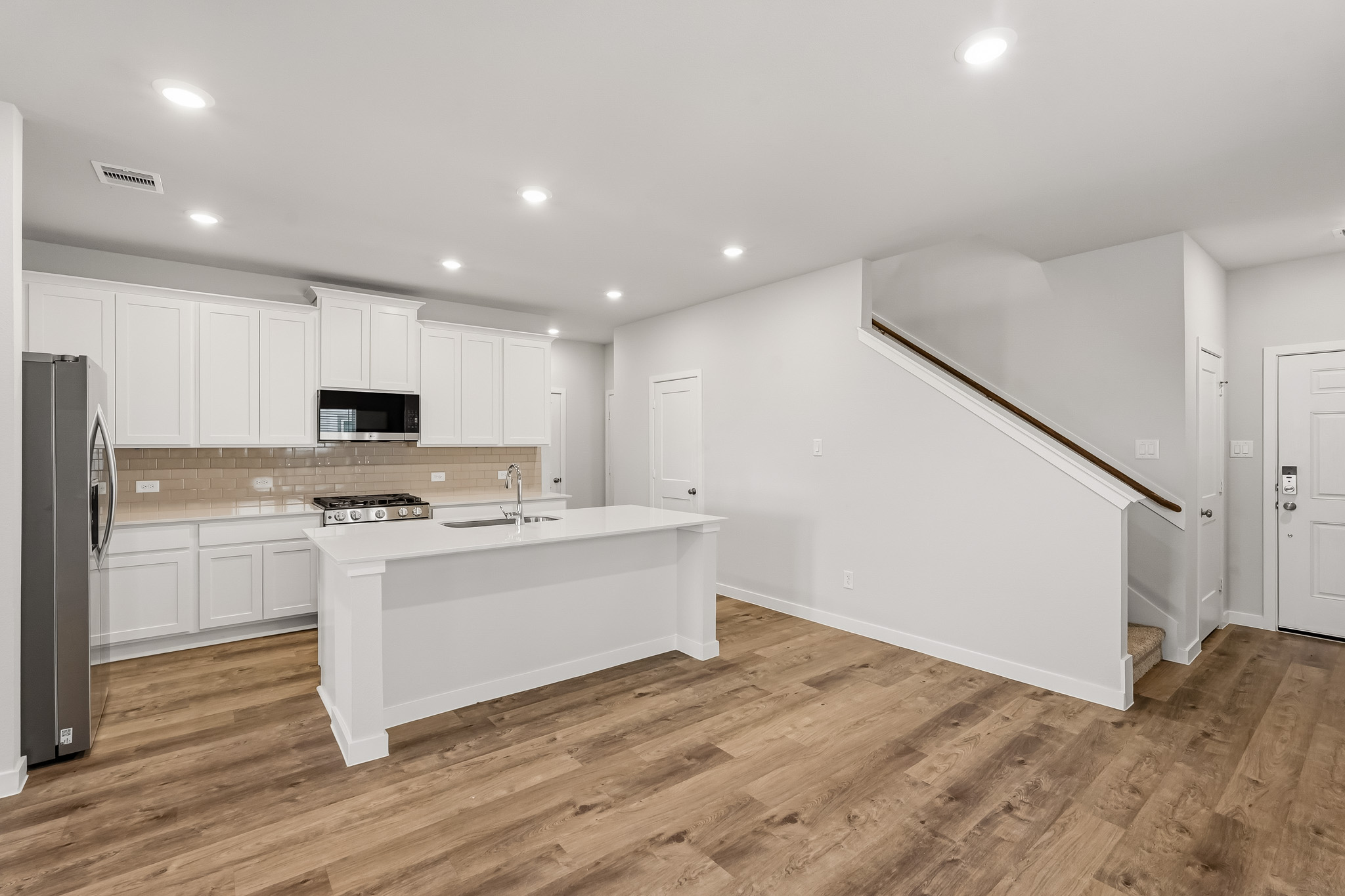 A kitchen with white cabinets.