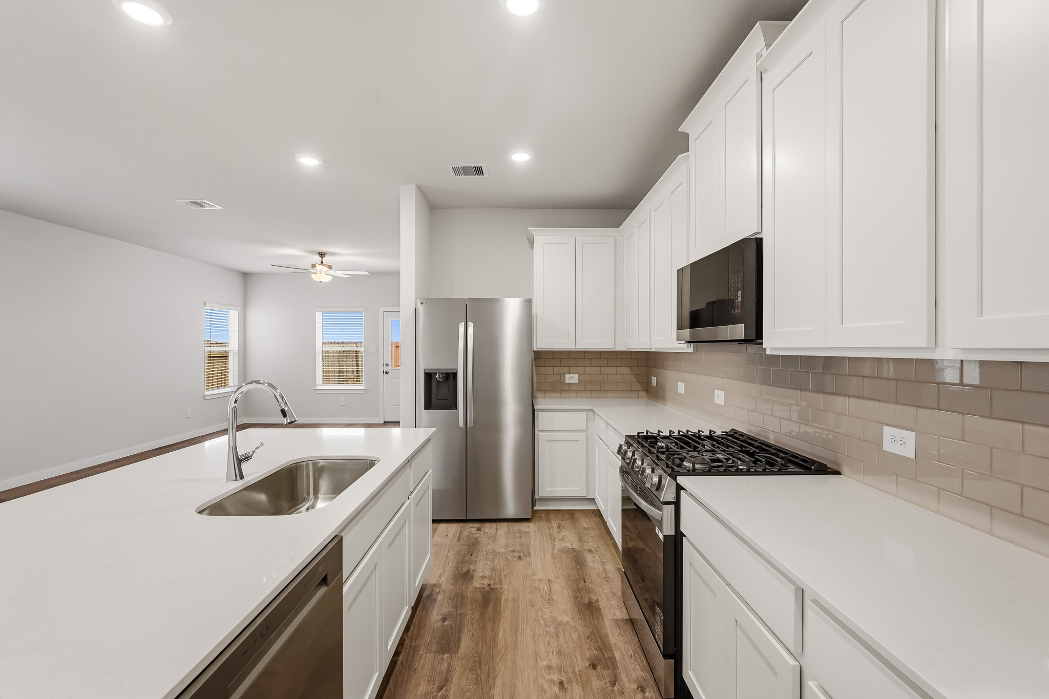 A kitchen with white cabinets.