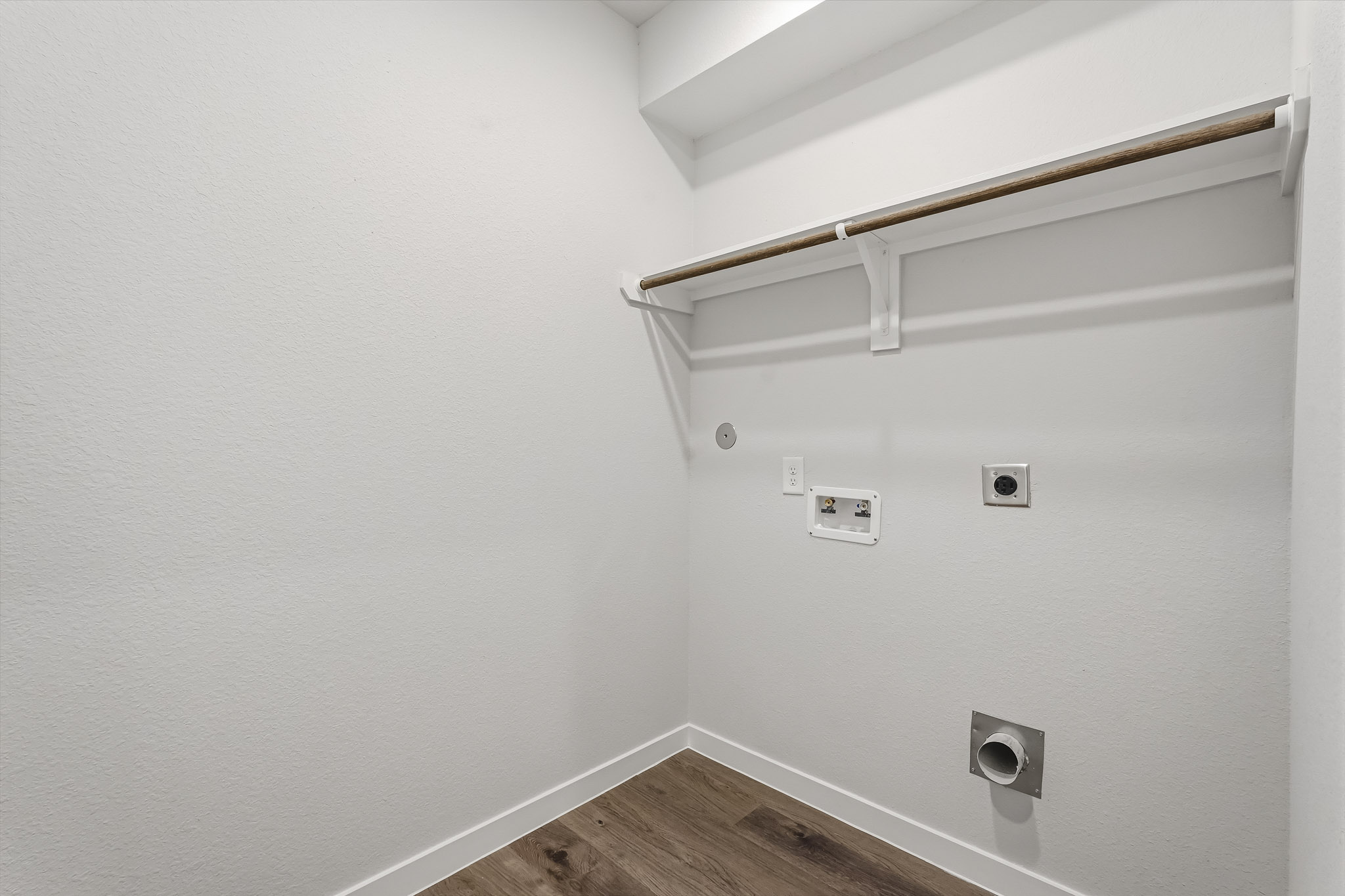 A white wall with a light fixture.