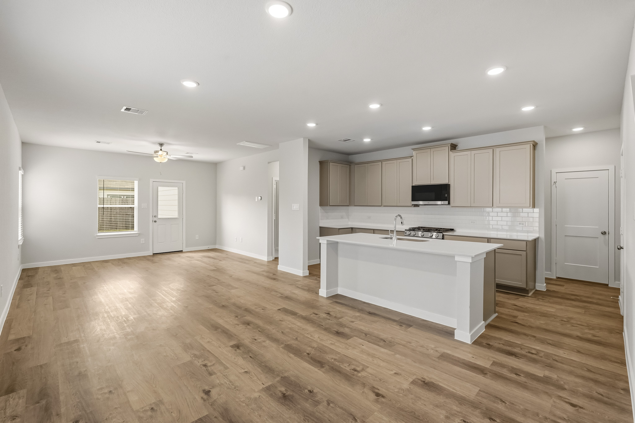 A large kitchen with white cabinets.