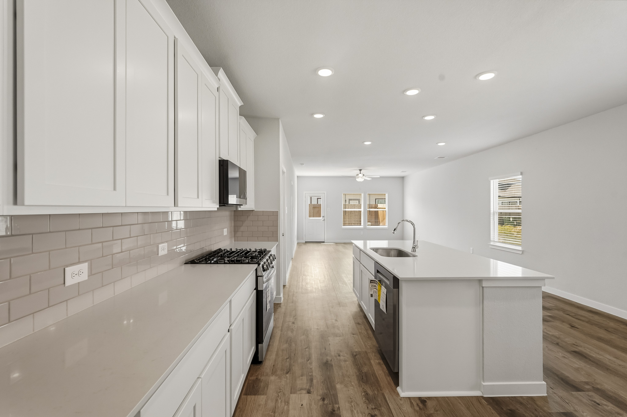A kitchen with white cabinets.