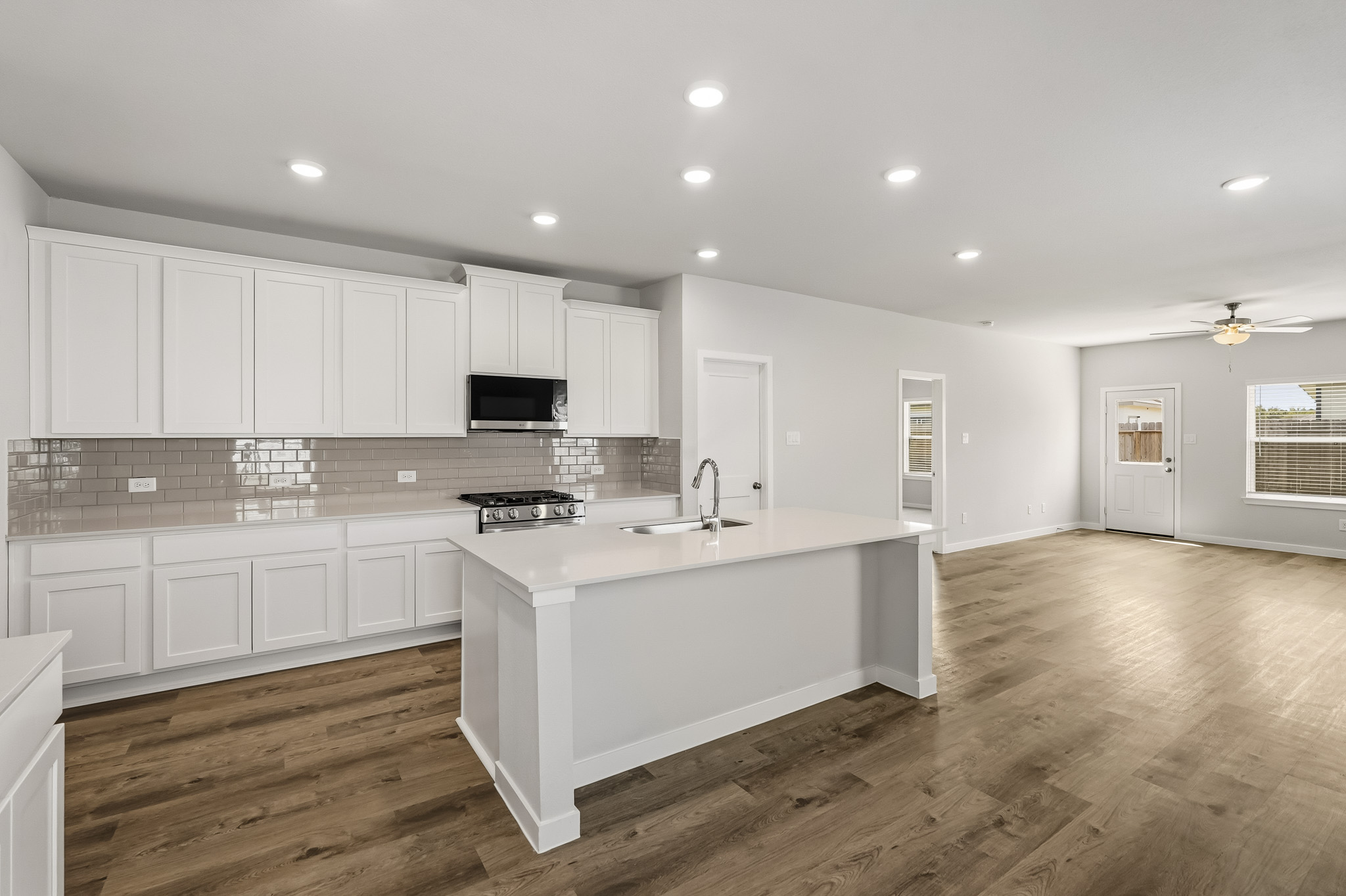 A kitchen with white cabinets.