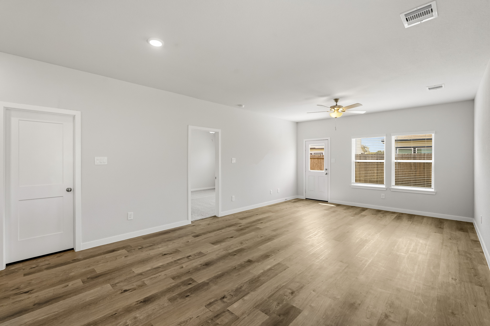 A room with a wood floor and white doors.