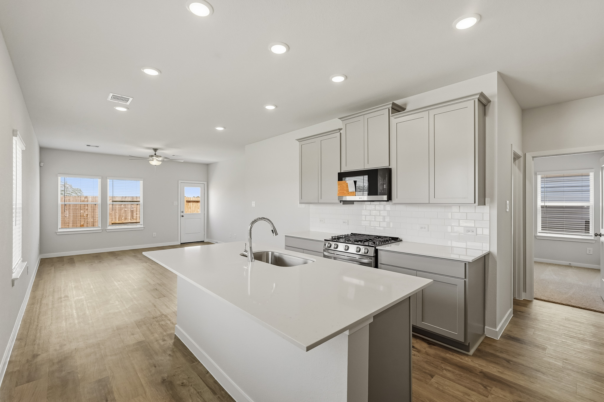 A kitchen with white cabinets.