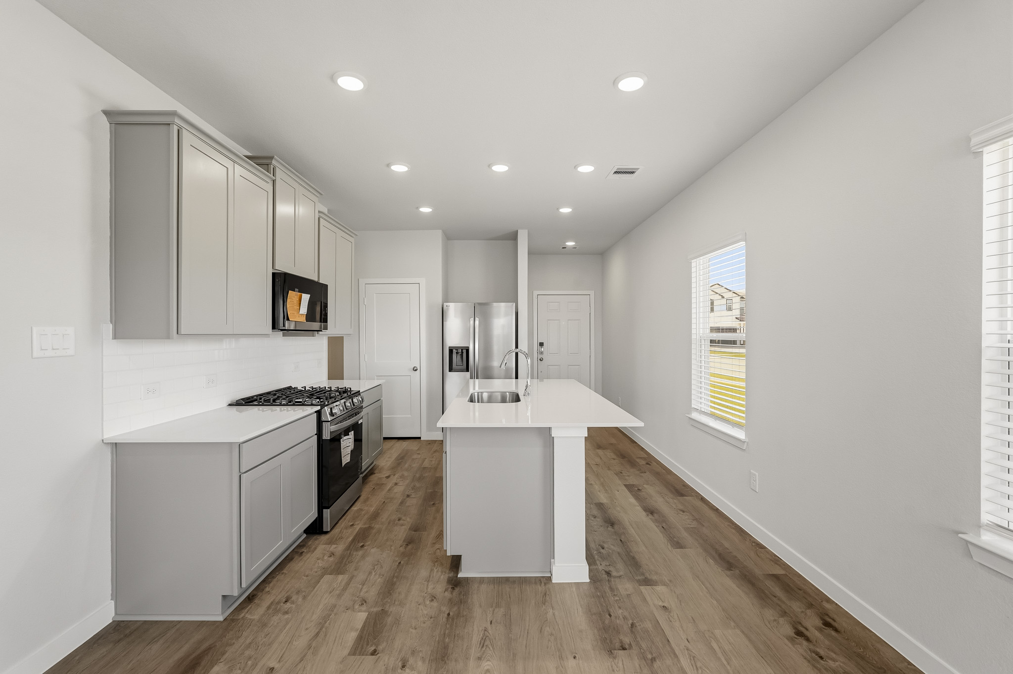 A kitchen with white cabinets.