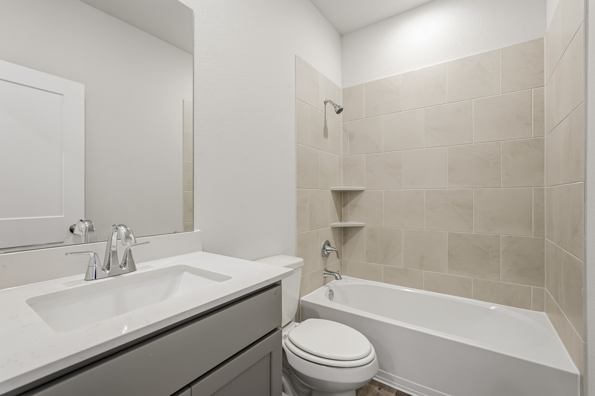 A bathroom with a tub sink and toilet.