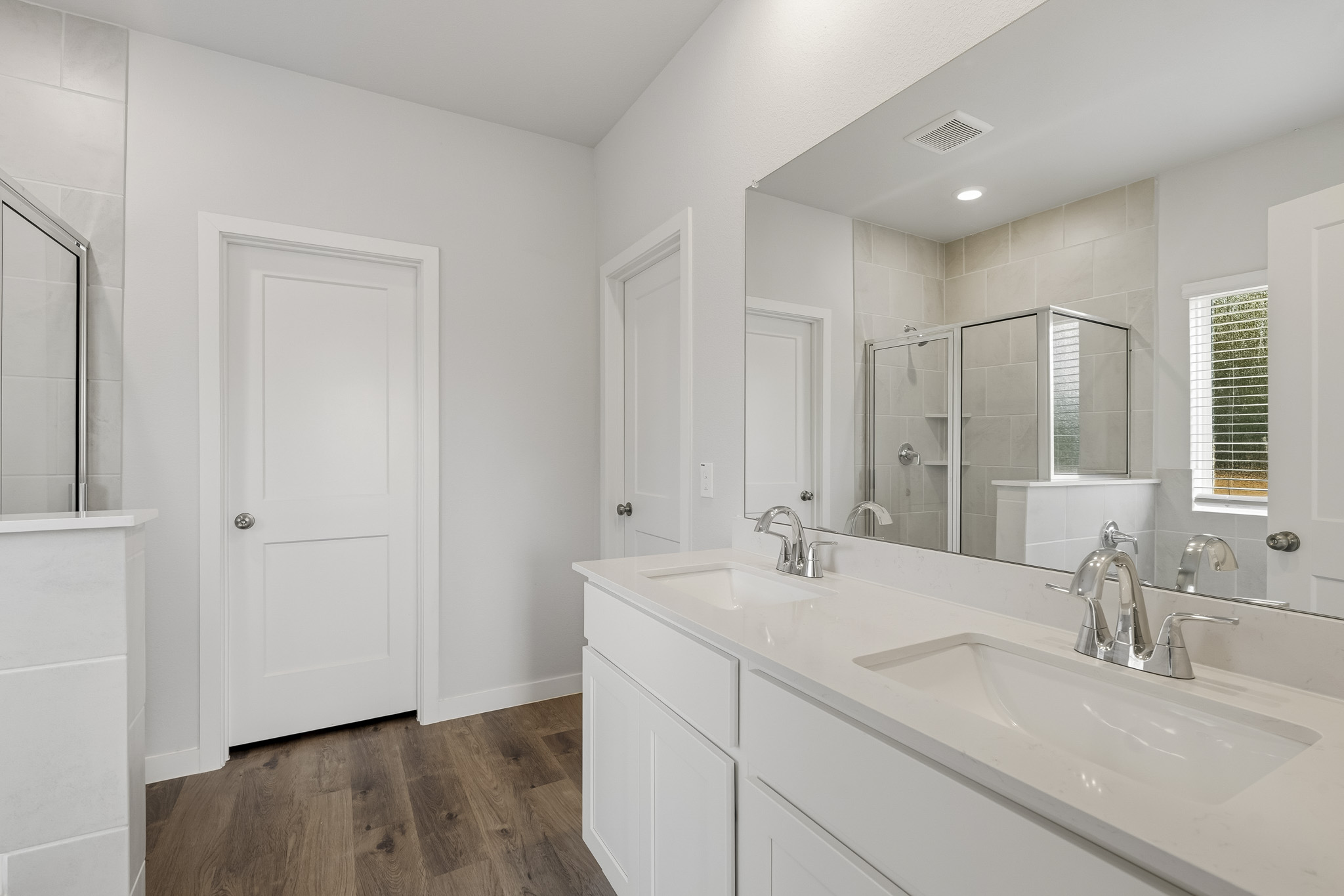 A bathroom with white cabinets.