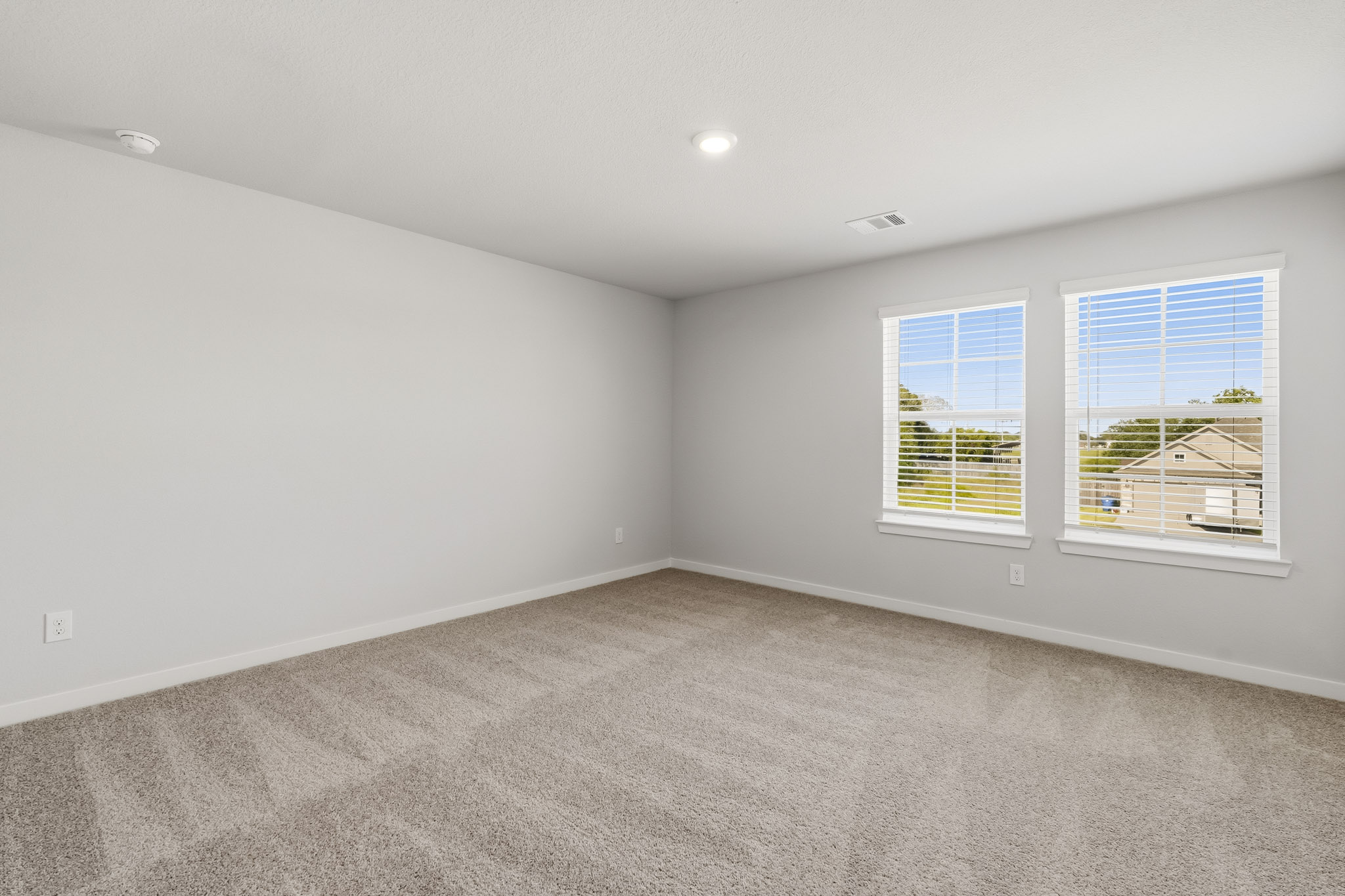 A room with a window and a carpet.