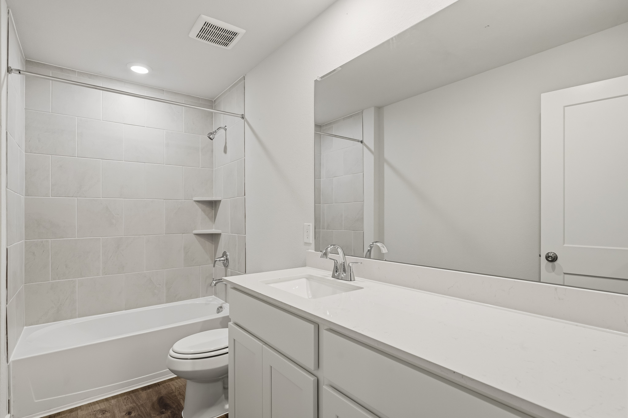 A bathroom with a tub sink and toilet.