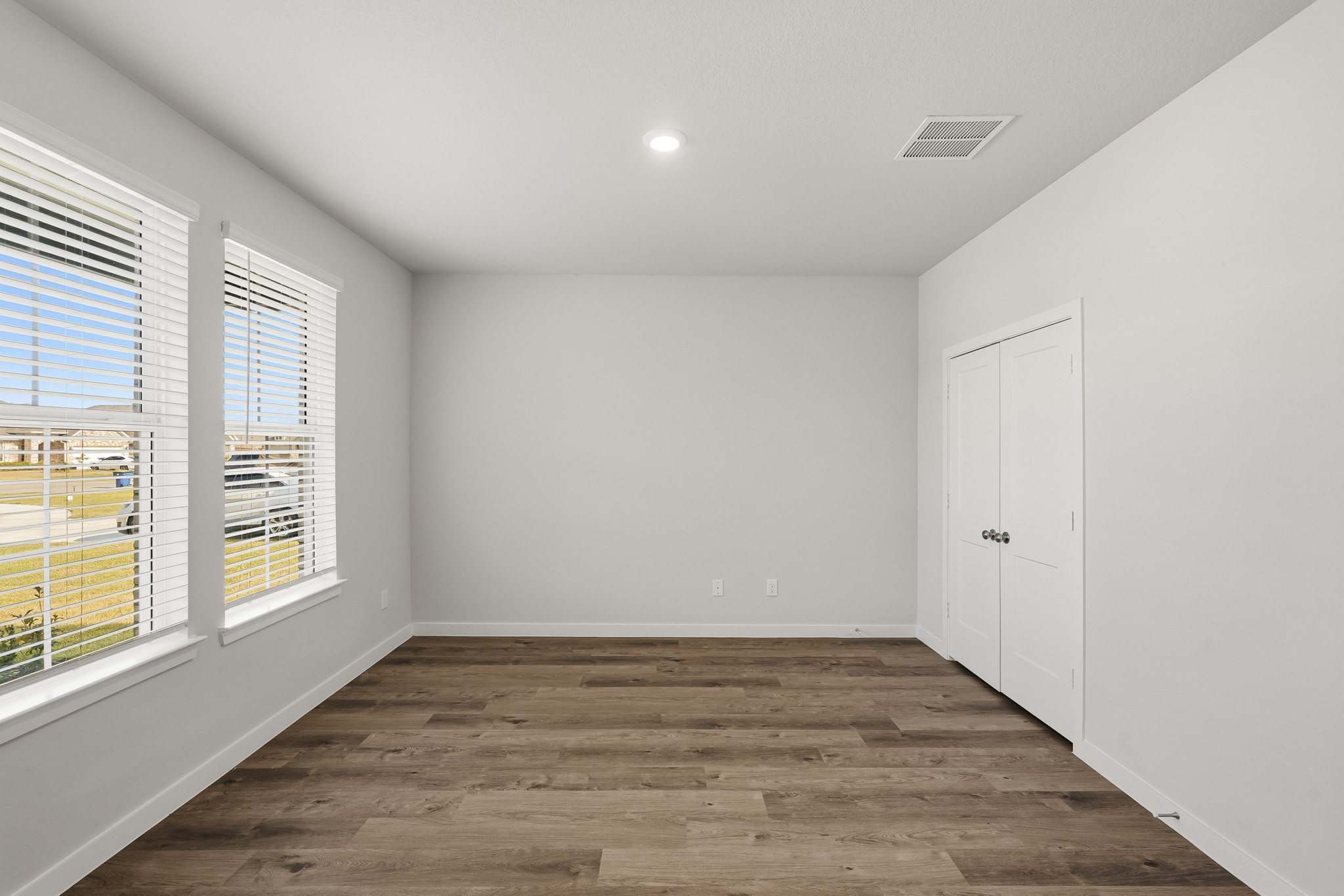 A room with white walls and windows.
