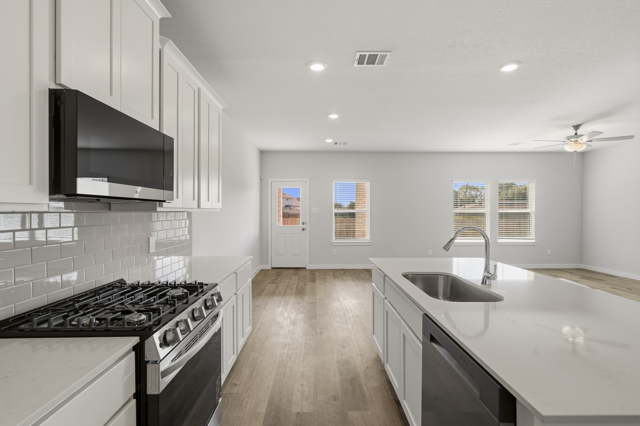 A kitchen with white cabinets.