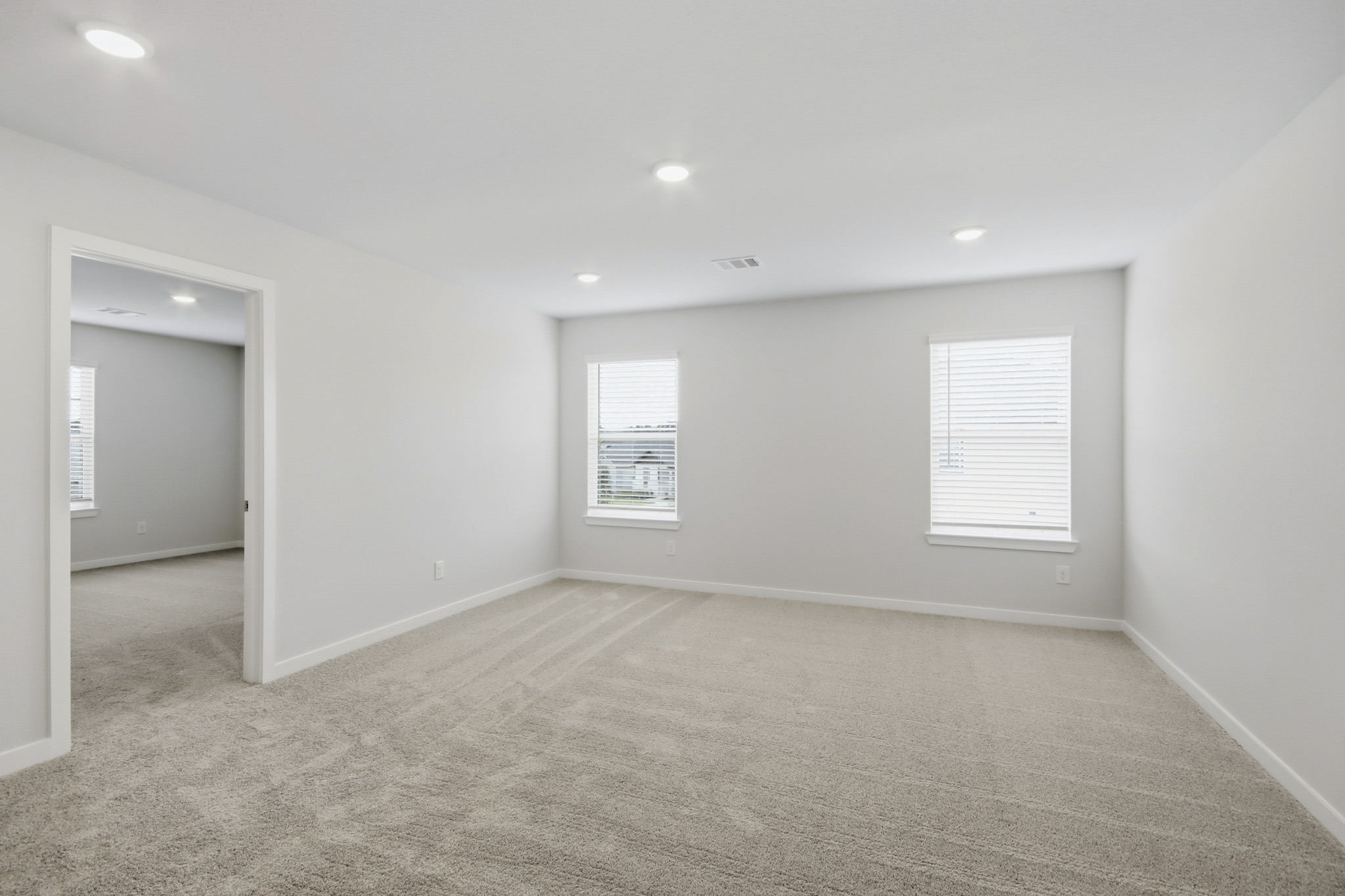 A room with a carpet and a door.