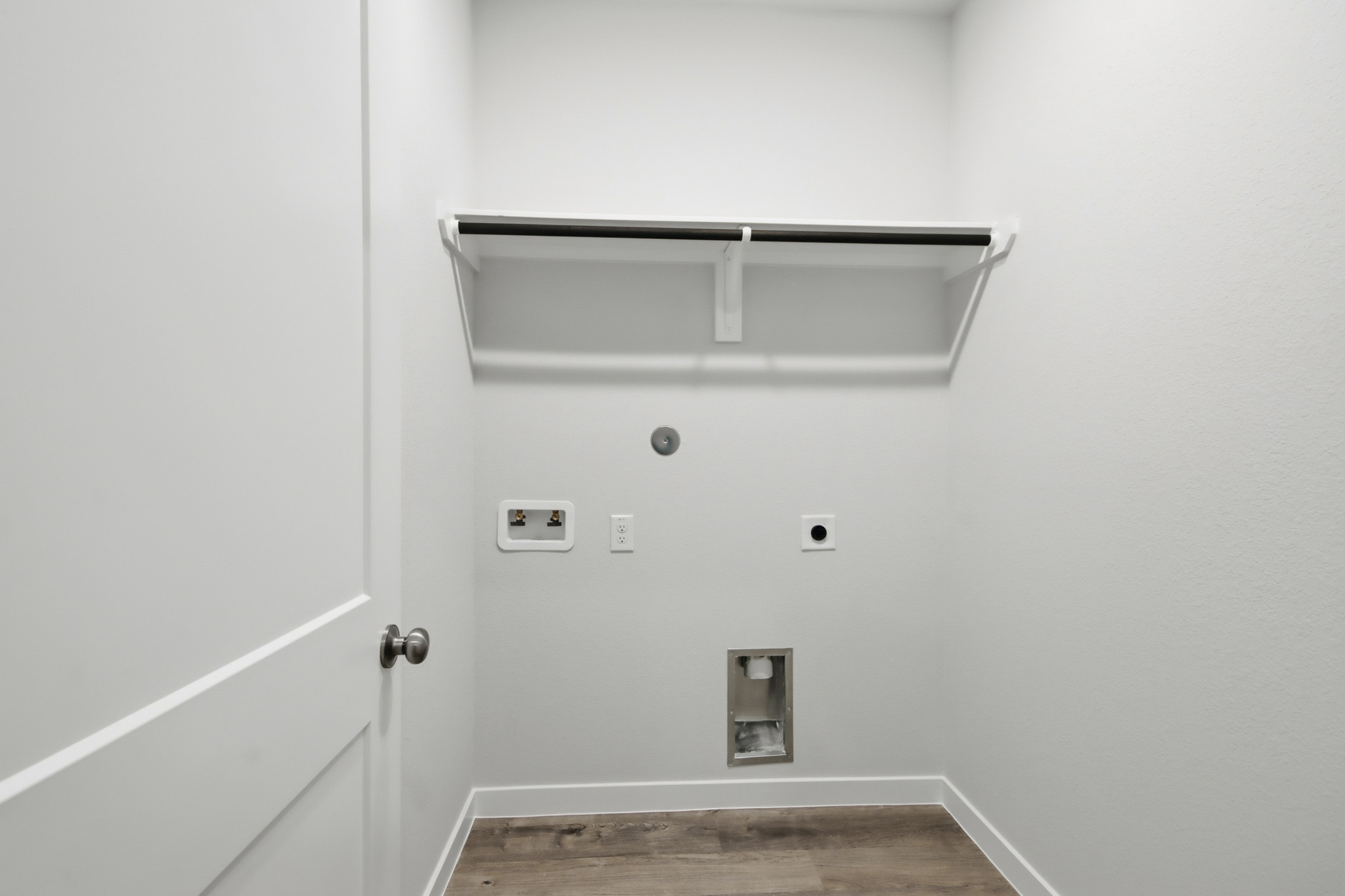A white wall with a light fixture.
