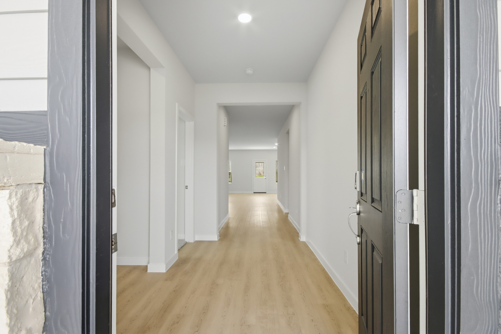A long hallway with white walls.