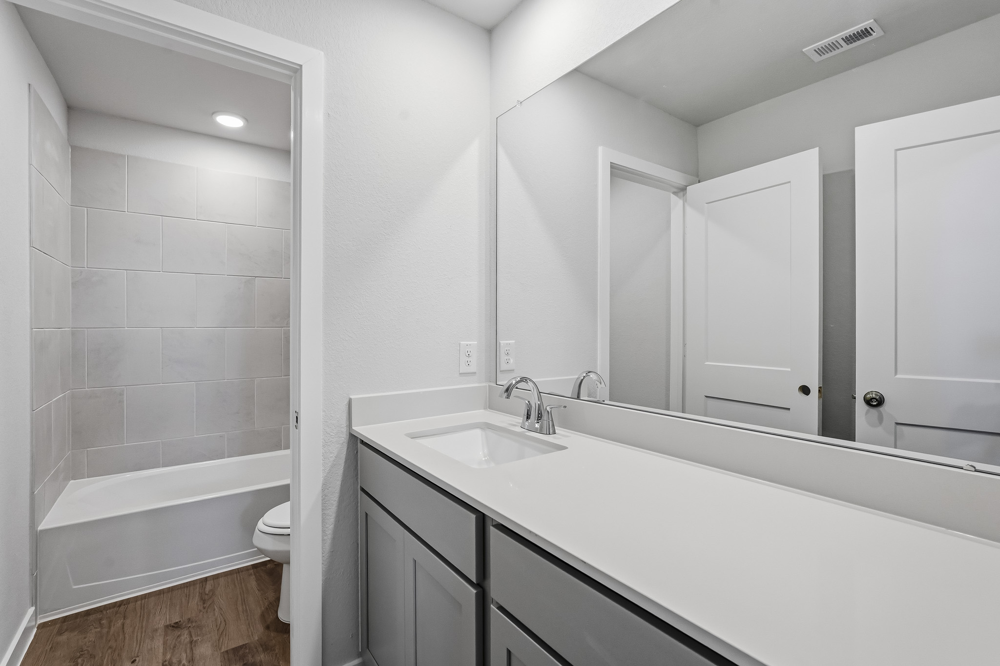 A bathroom with a tub sink and toilet.