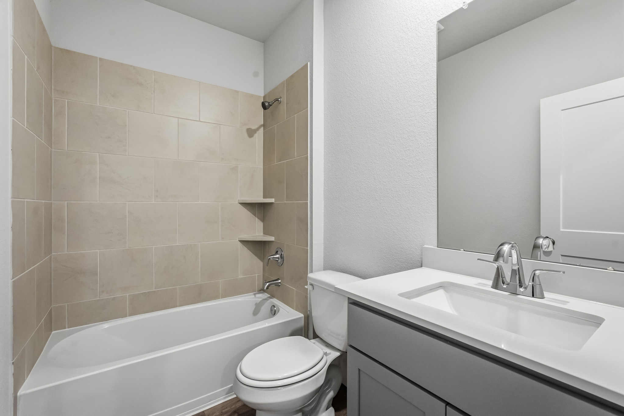 A bathroom with a tub sink and toilet.