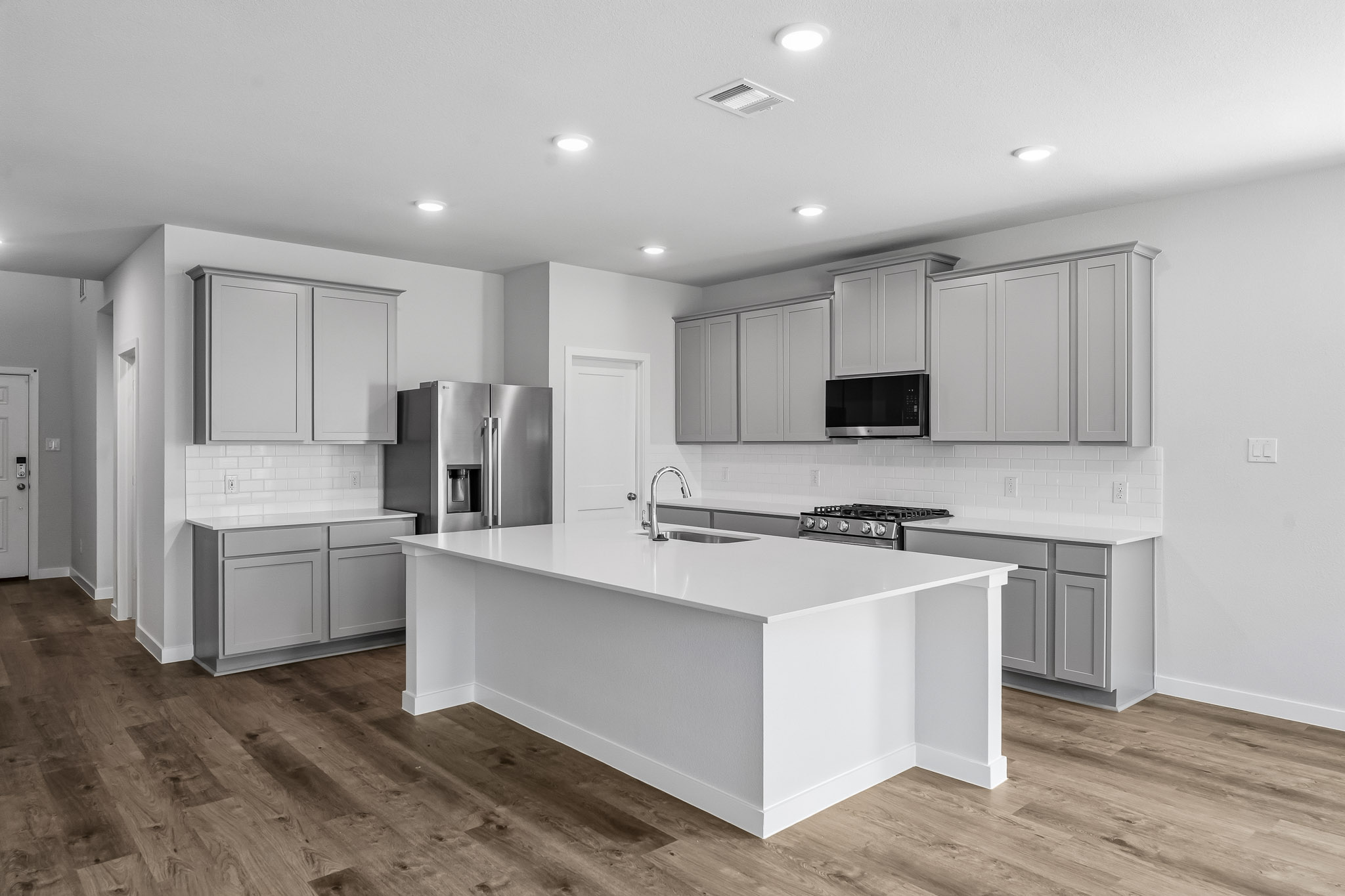A kitchen with white cabinets.