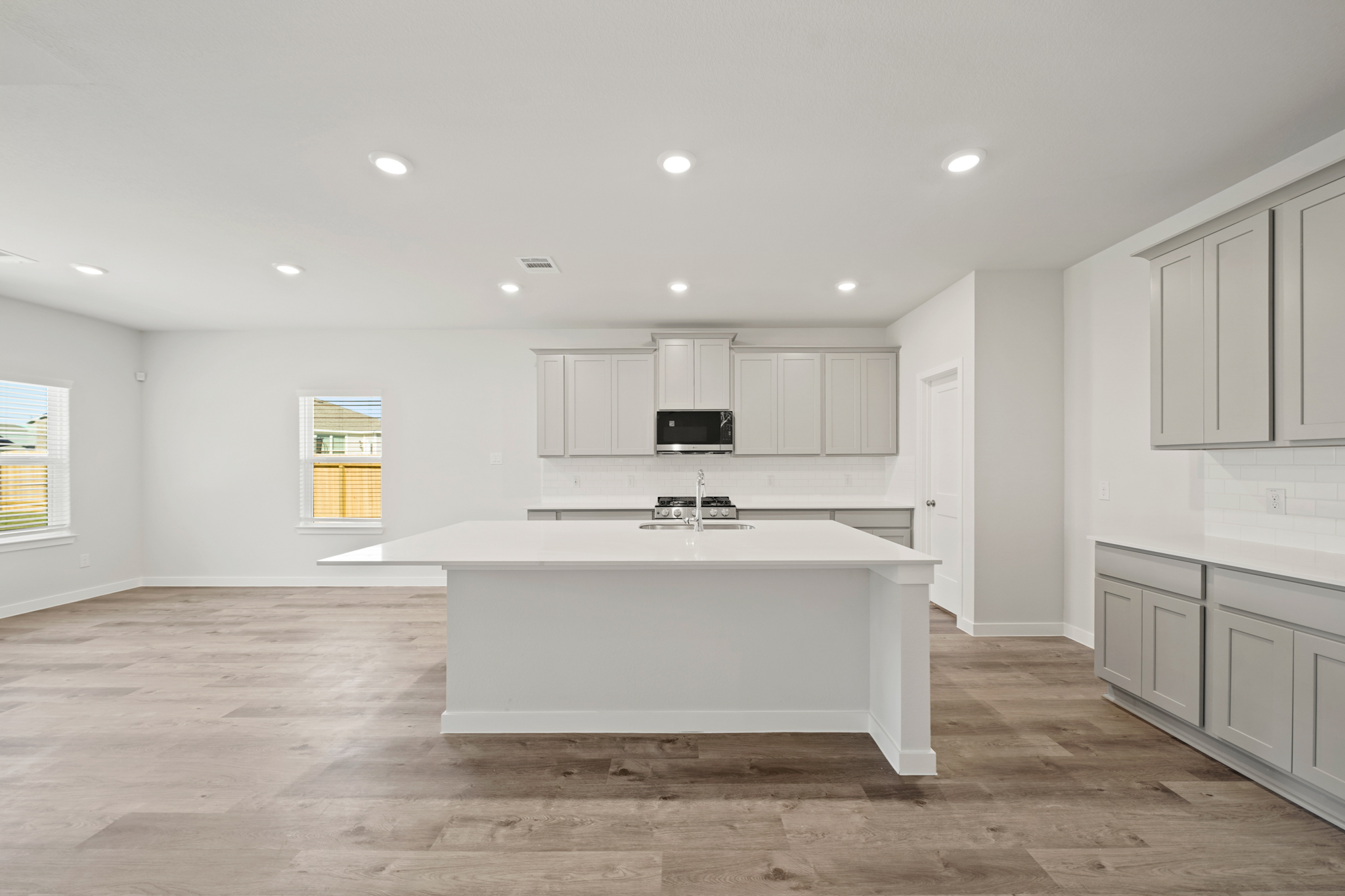 A kitchen with white cabinets.