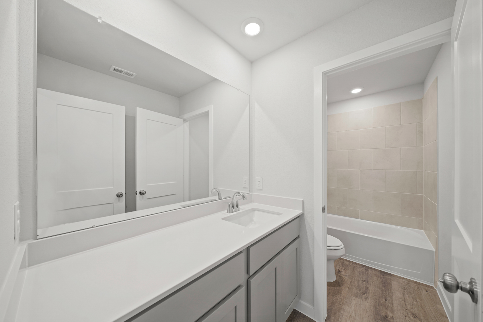 A bathroom with a tub sink and toilet.