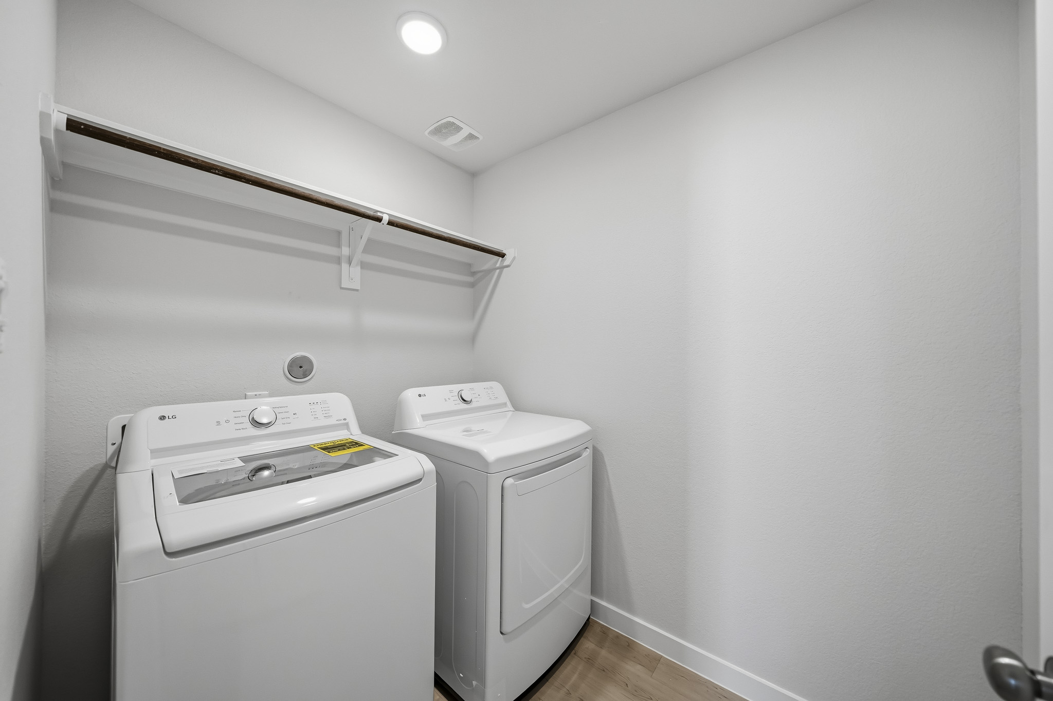 A washing machine and dryer in a room.