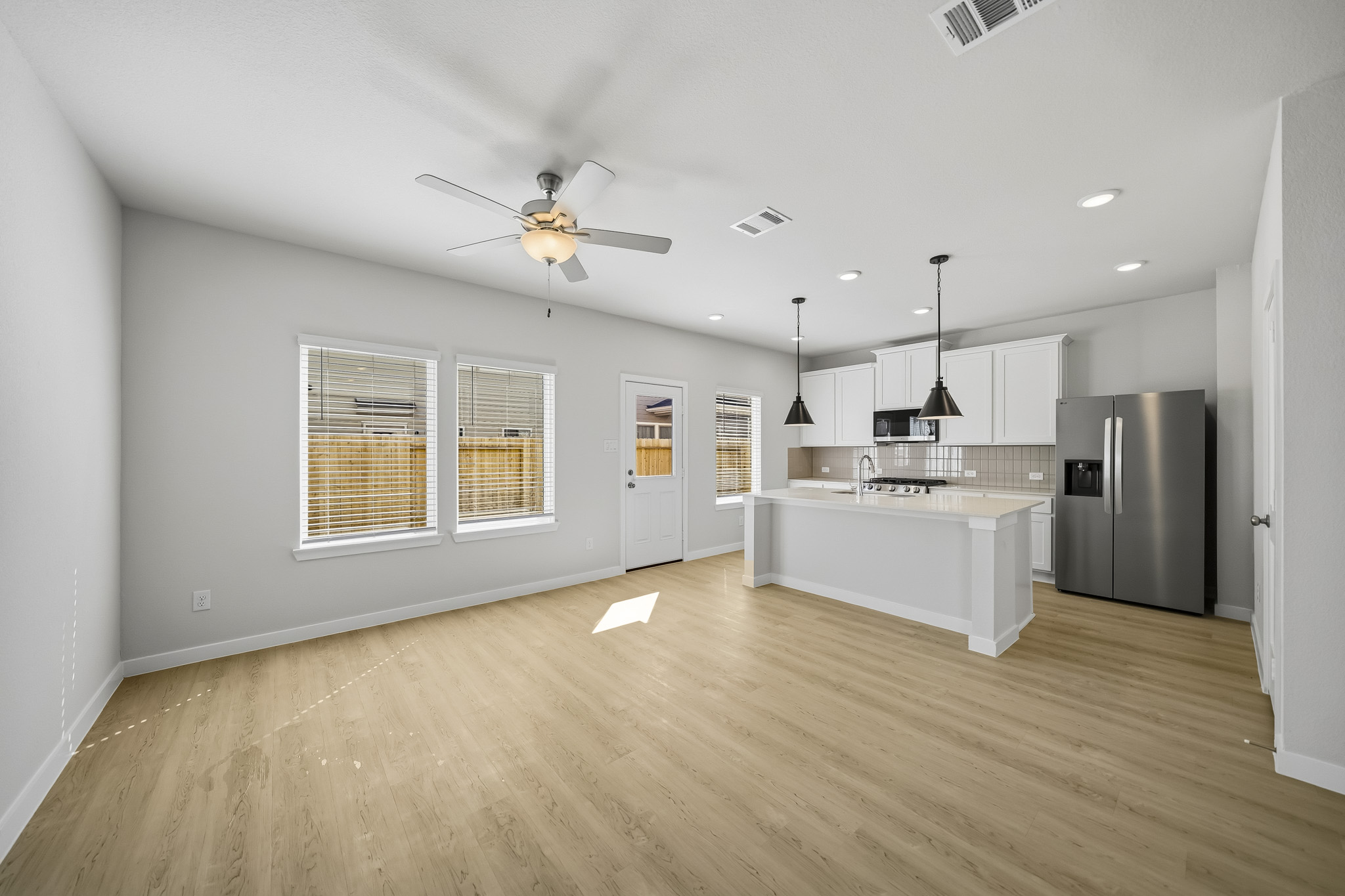 A kitchen with a wood floor.