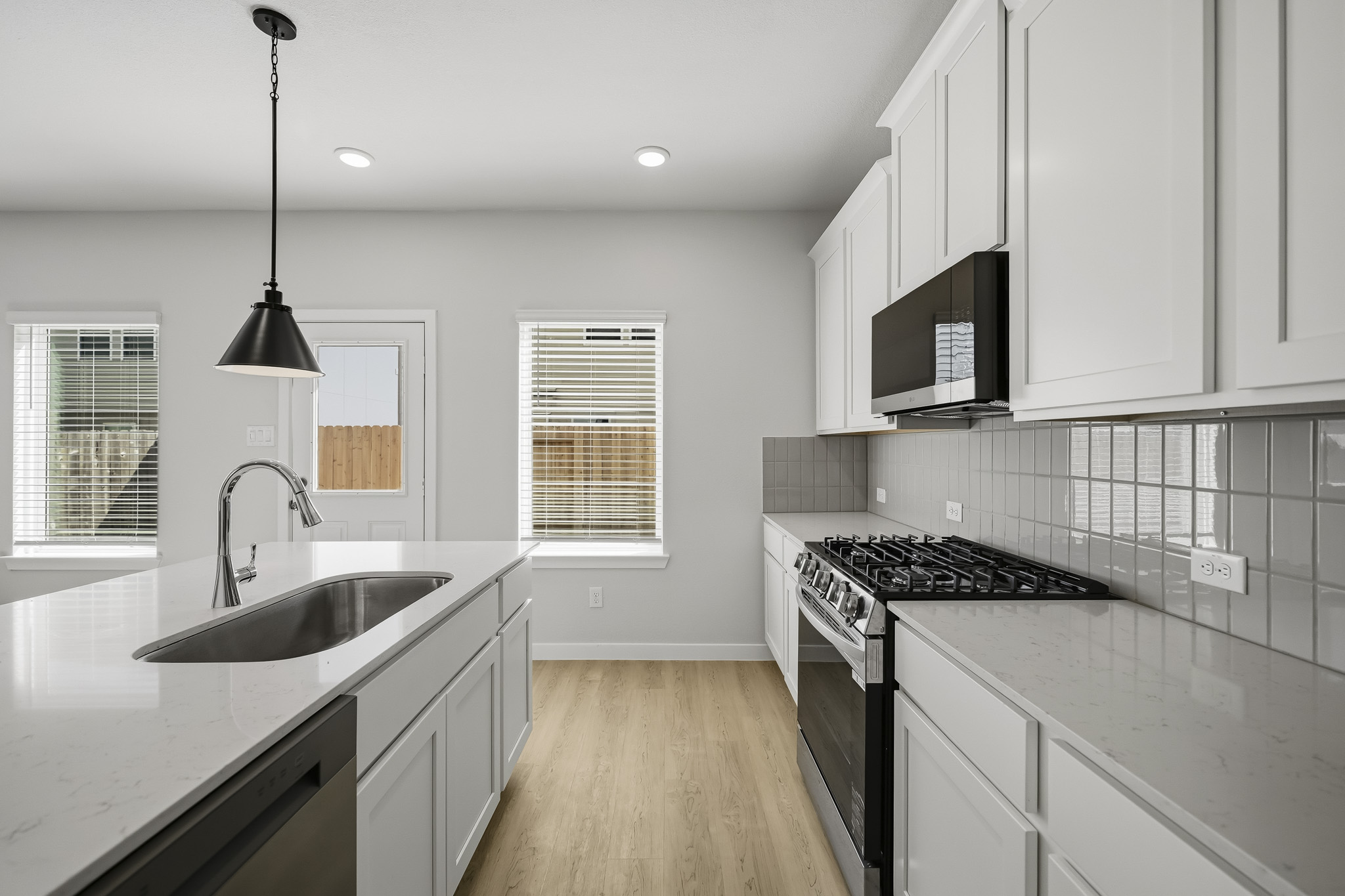 A kitchen with white cabinets.