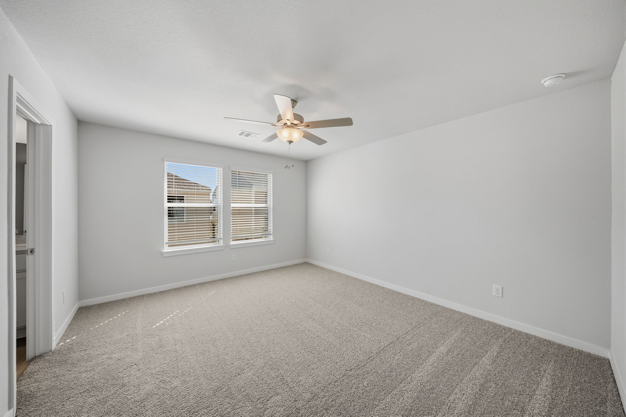 A room with a ceiling fan and a ceiling fan.