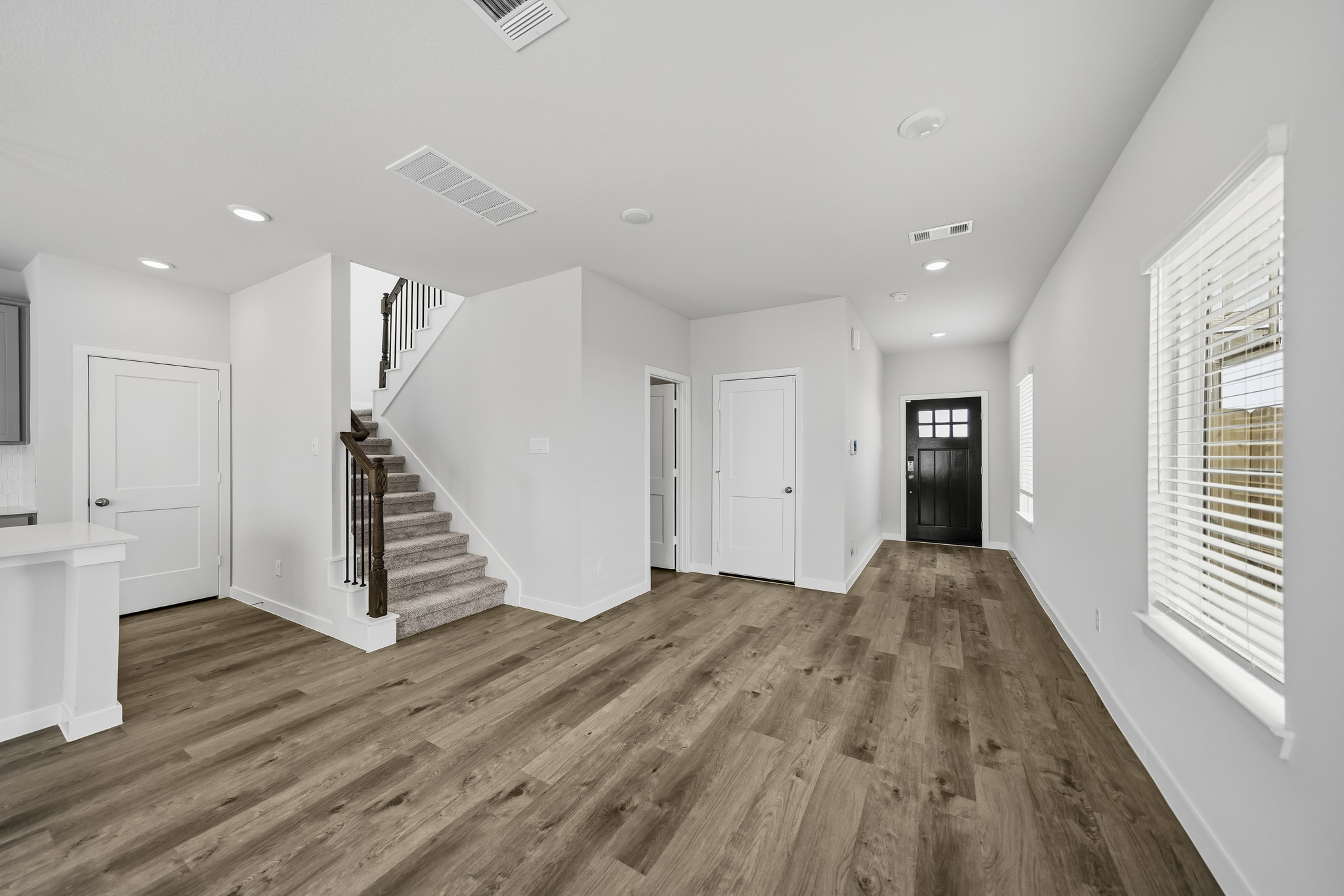 A large empty room with white doors.