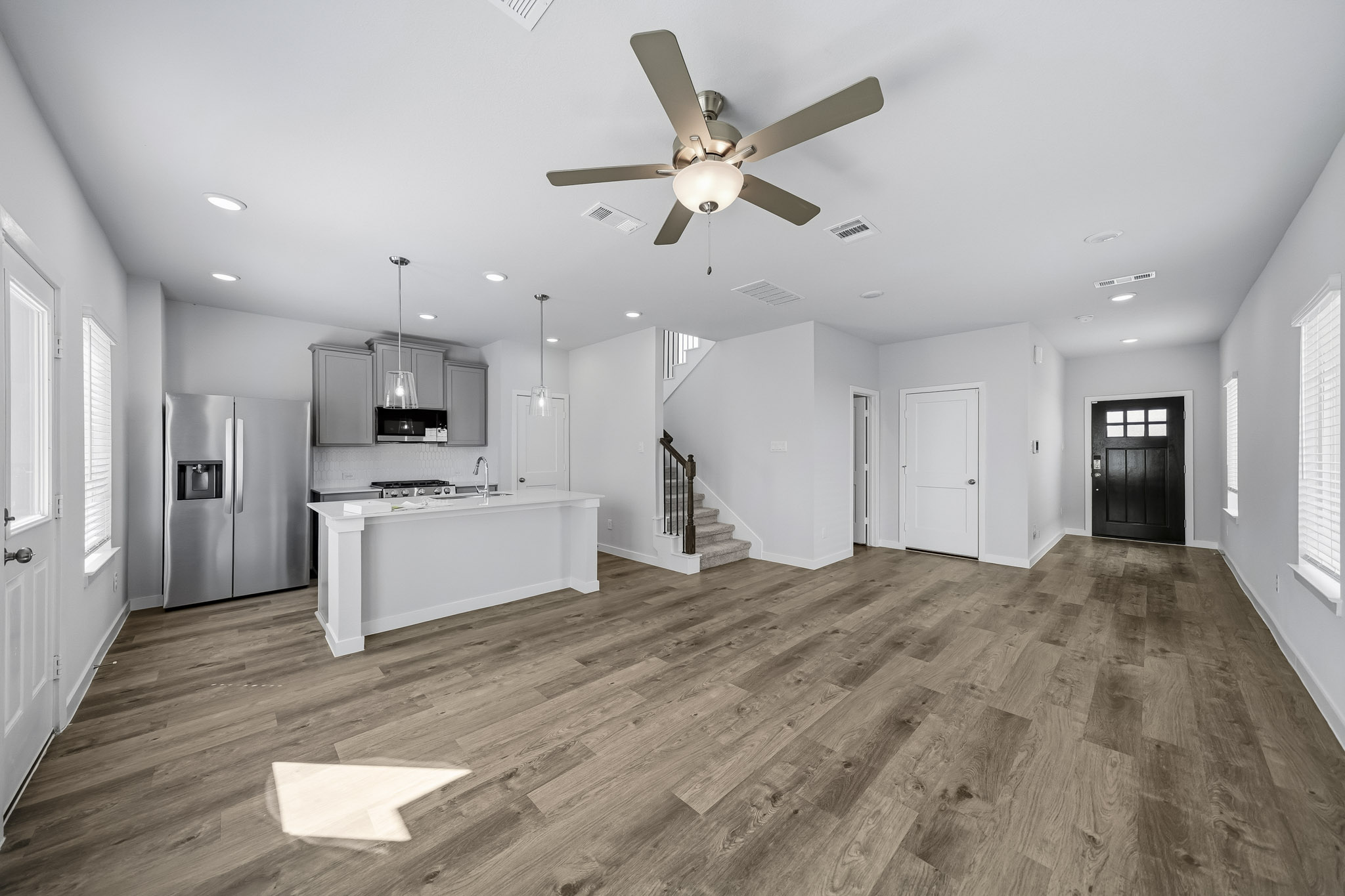 A large kitchen with a wood floor.