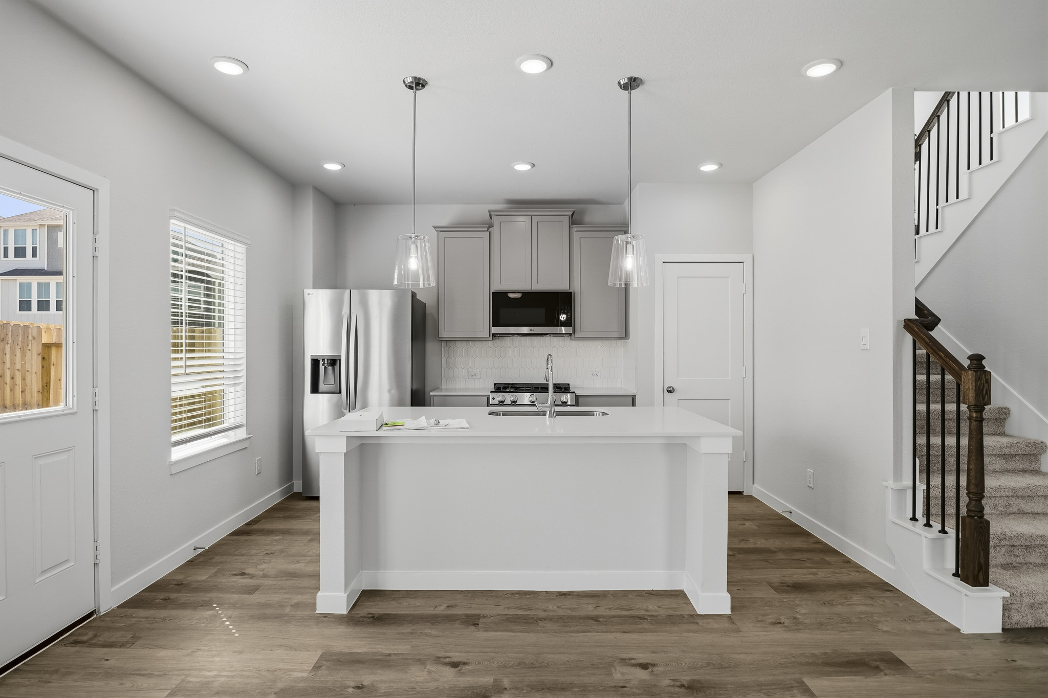 A kitchen with white cabinets.