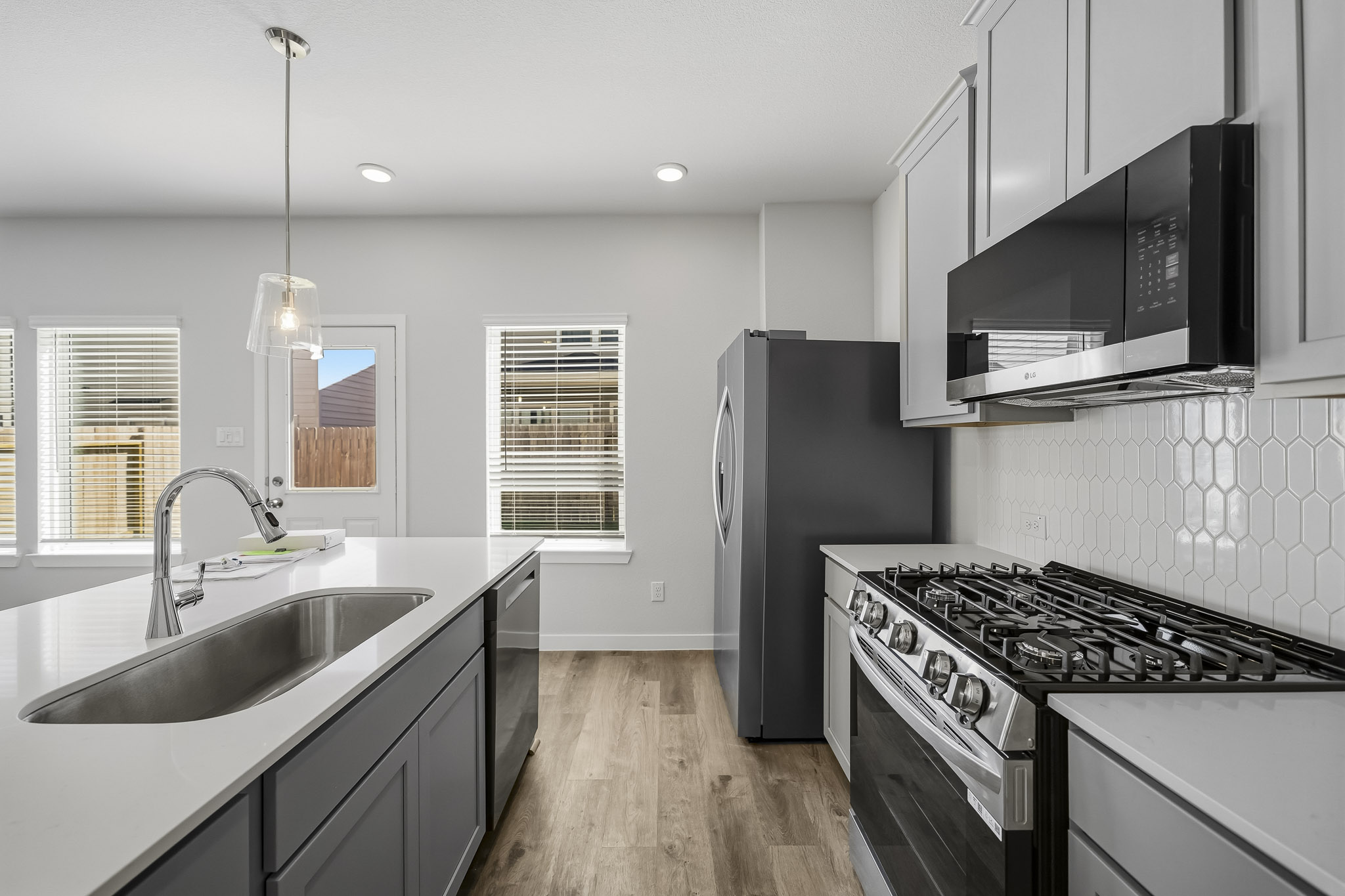 A kitchen with white tiles.