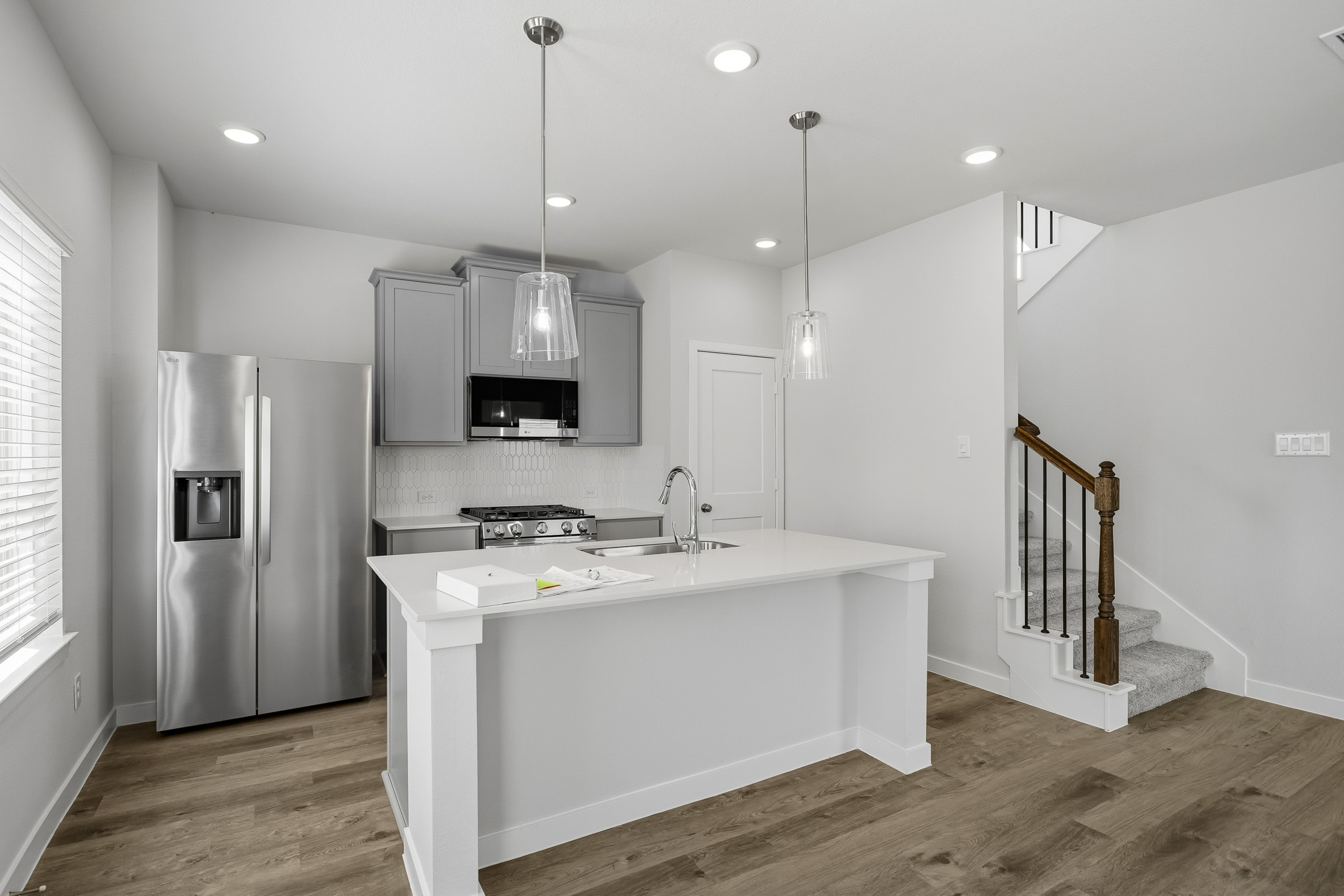 A kitchen with white cabinets.