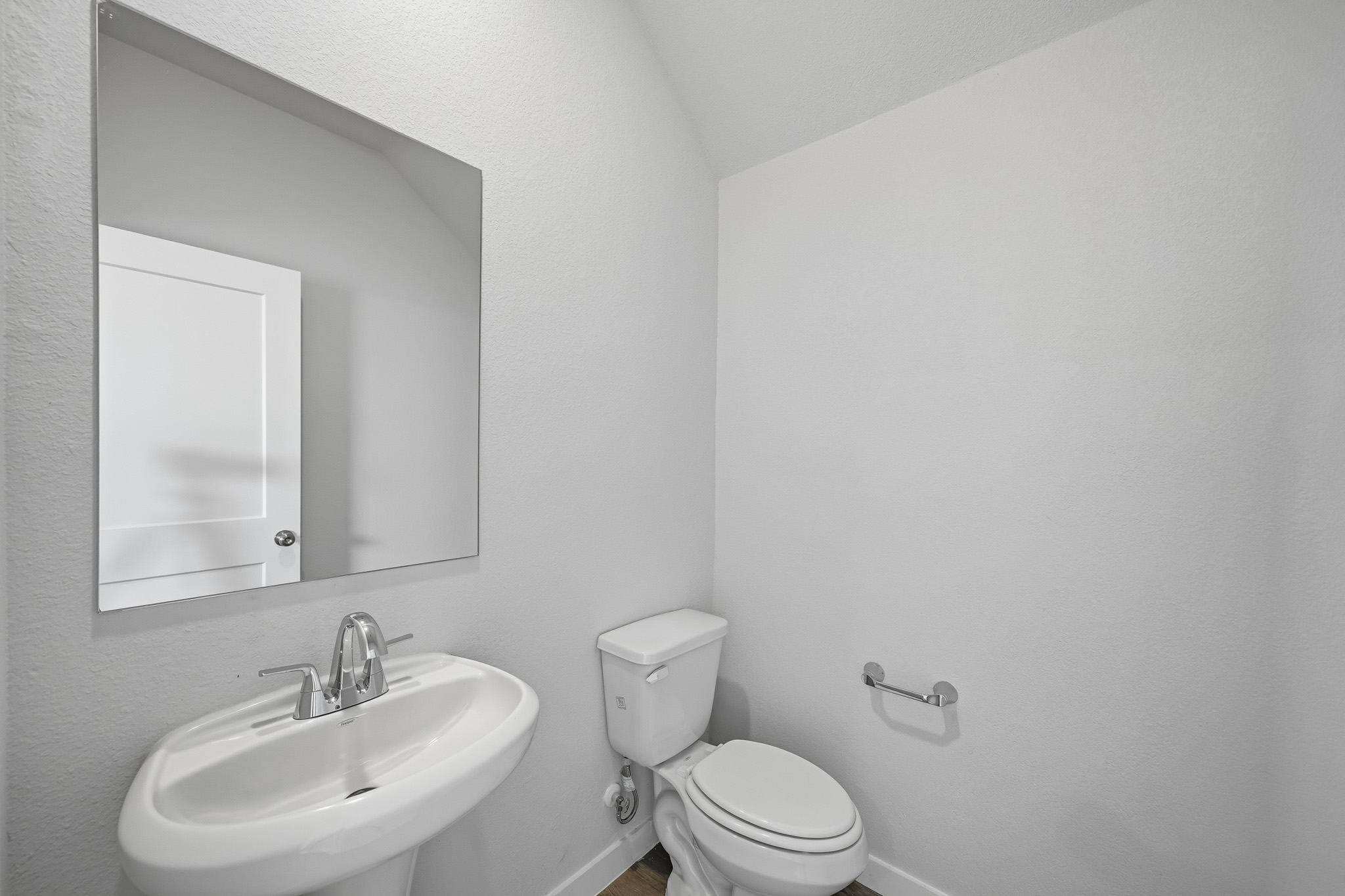 A bathroom with a sink and toilet.