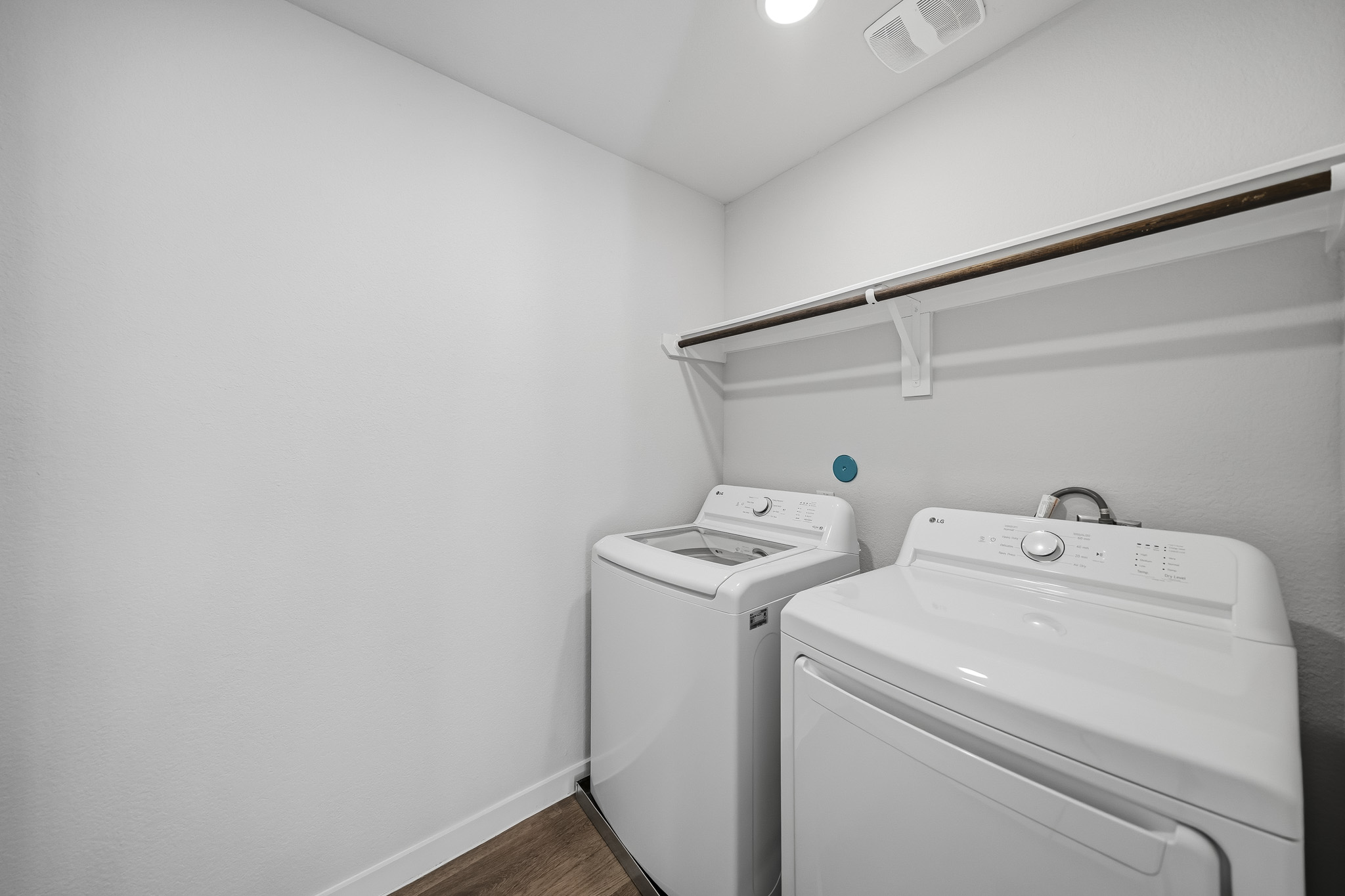 A washing machine and dryer in a room.