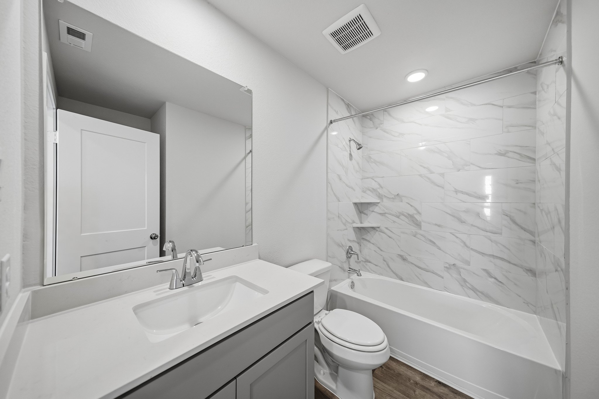 A bathroom with a tub sink and toilet.
