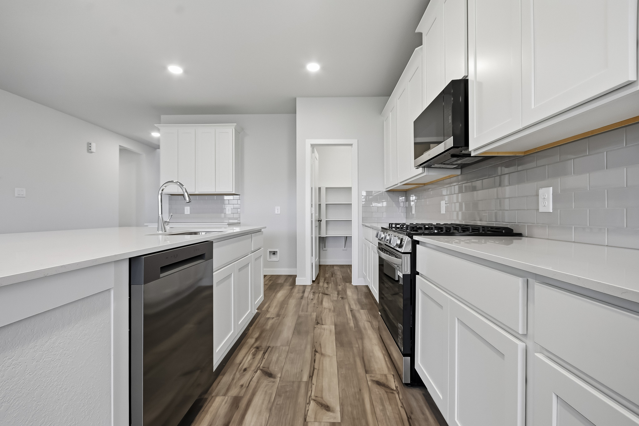 A kitchen with white cabinets.