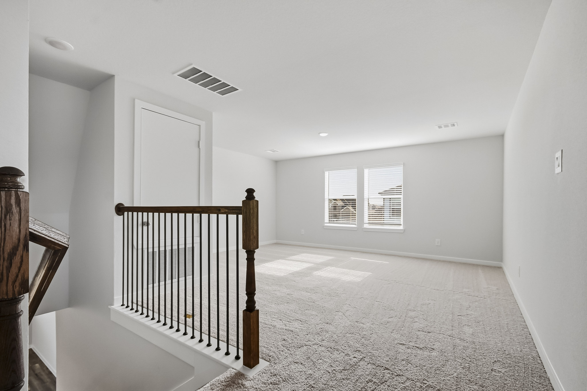 A room with a railing and a door.