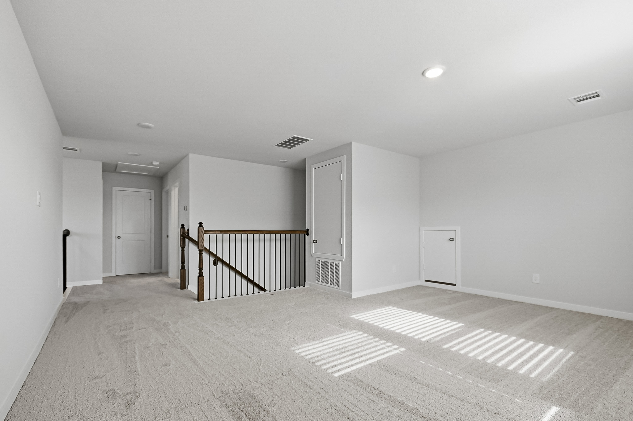 A room with a staircase and a railing.